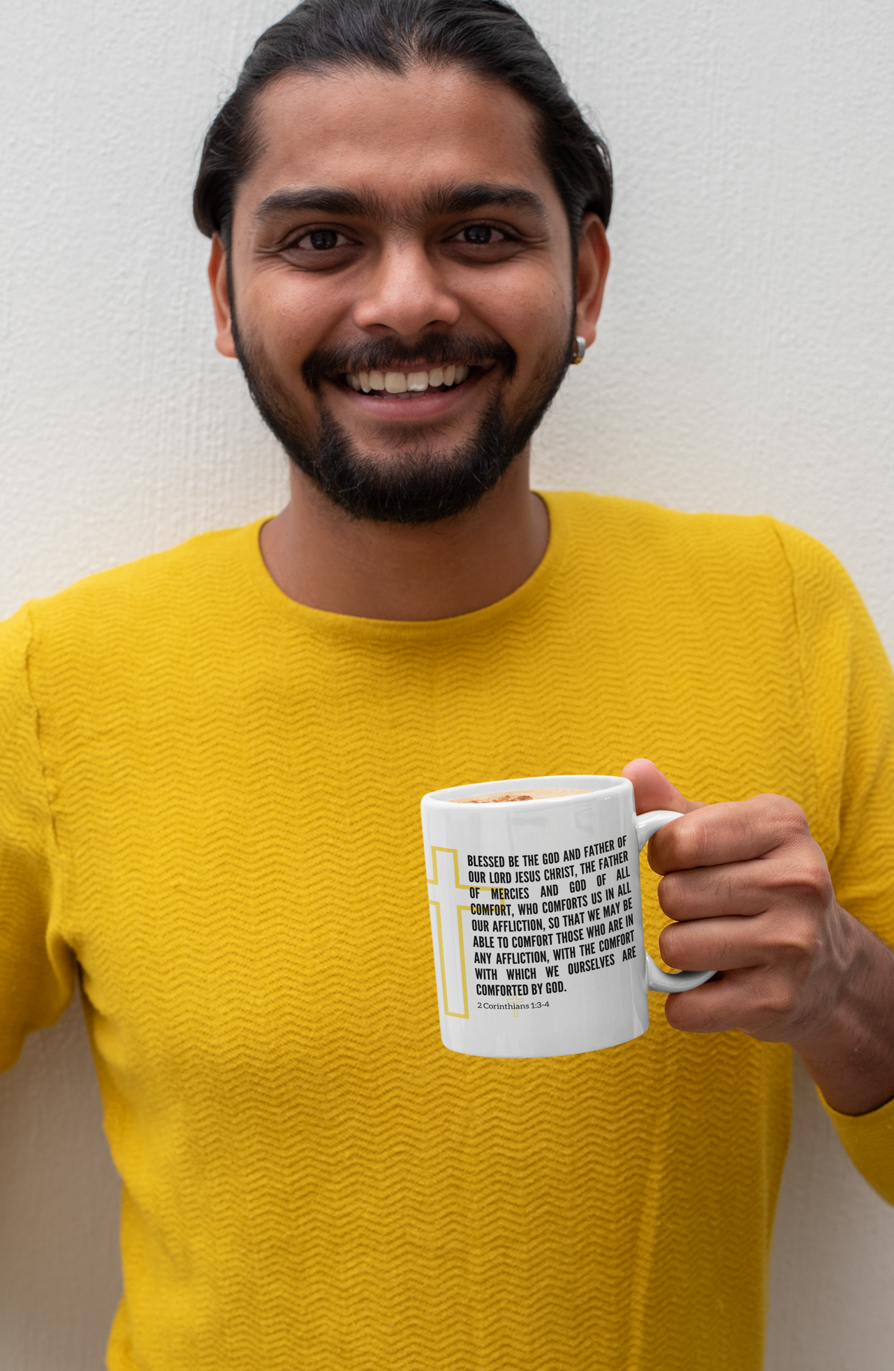 a man with a beard holding a coffee mug