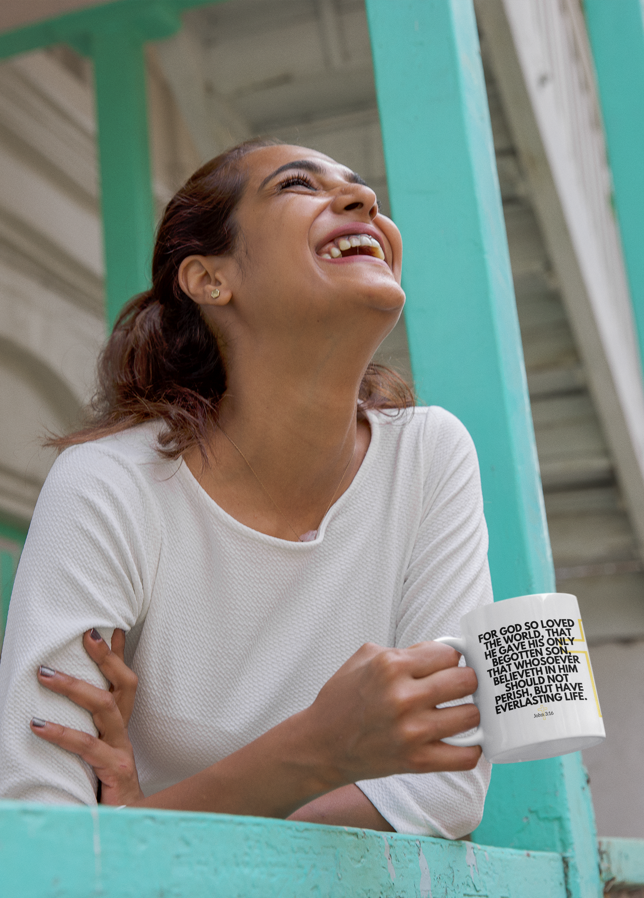 a woman smiling and holding a coffee mug