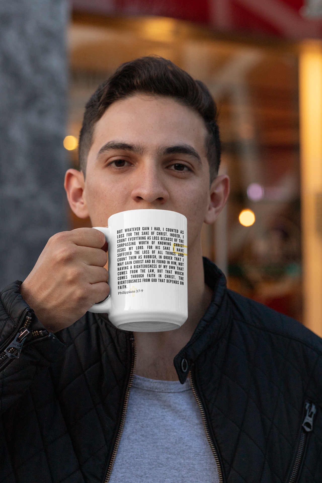 a man is holding a coffee mug in front of his face