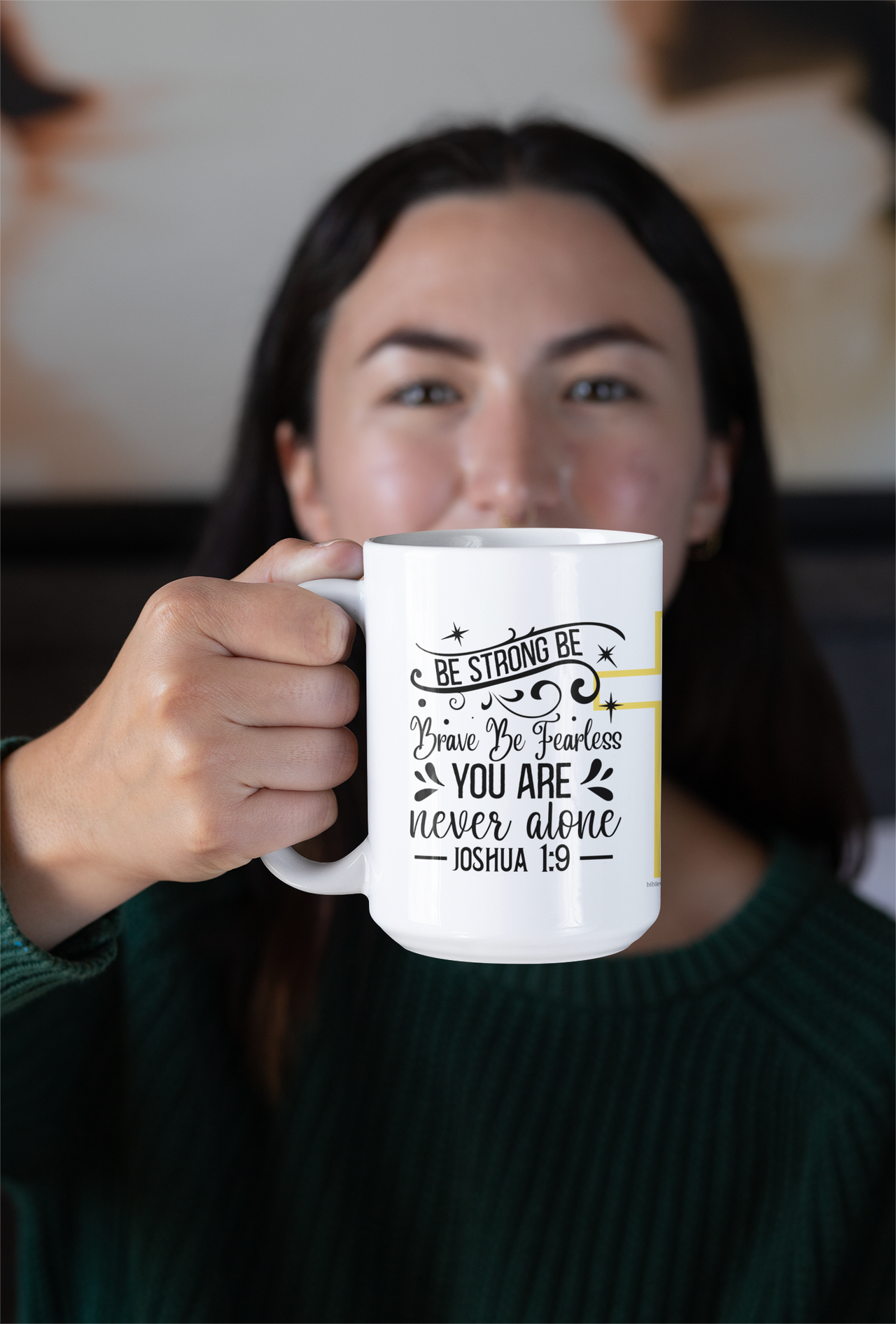 a woman holding a coffee mug with a quote on it