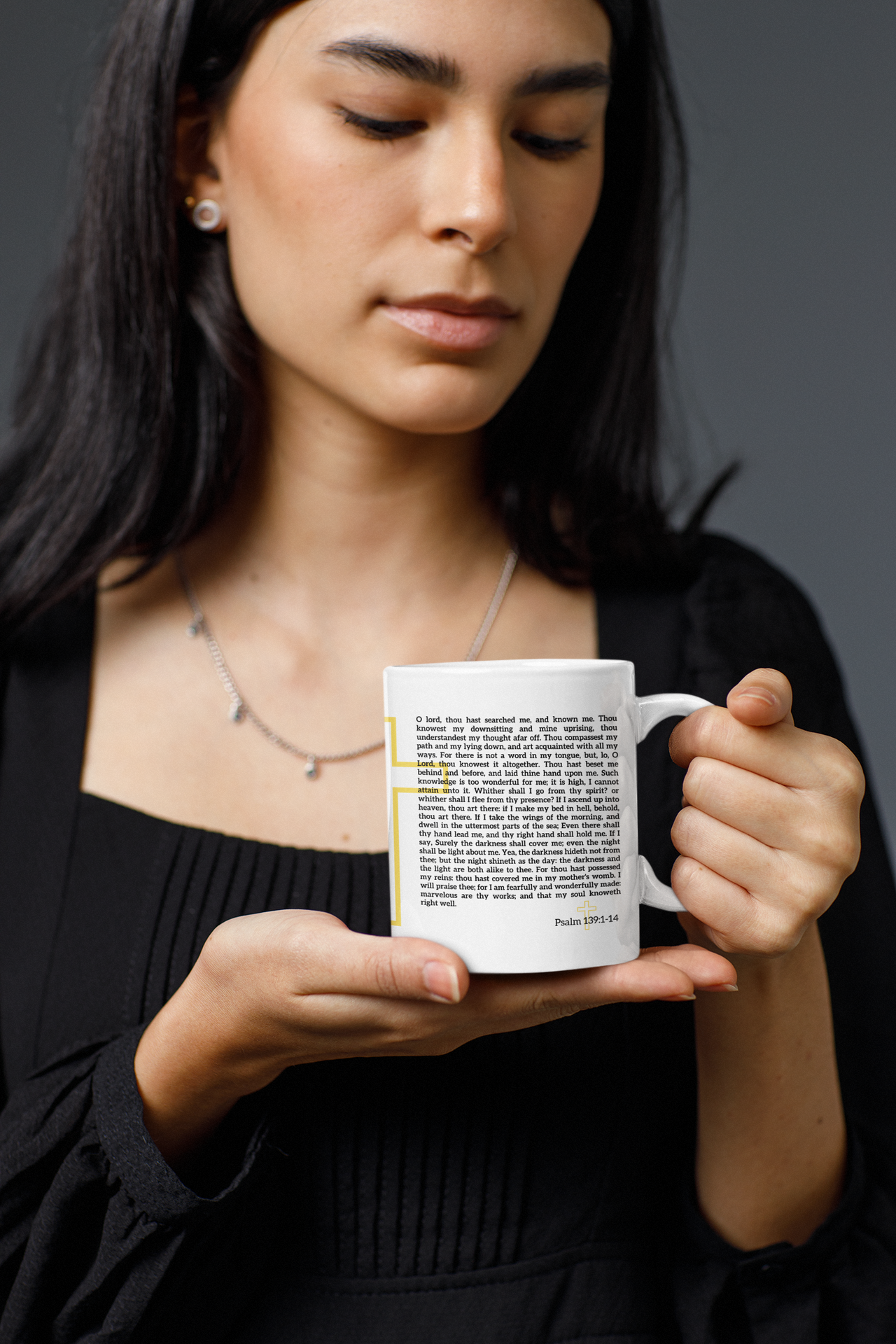 a woman holding a coffee mug in her hands