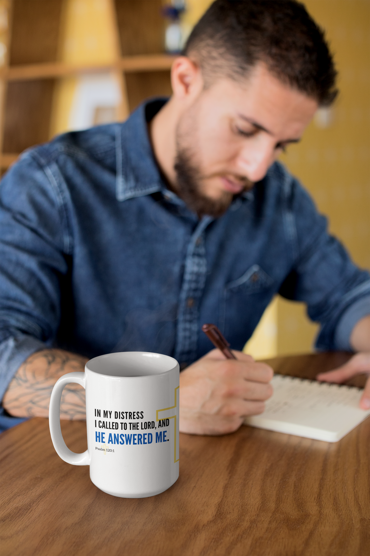 a man sitting at a table writing on a notepad