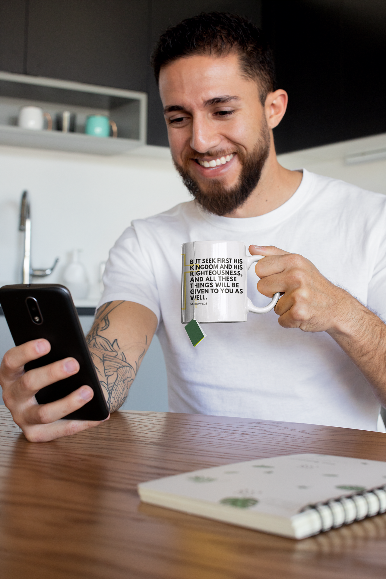 a man with a beard holding a coffee mug