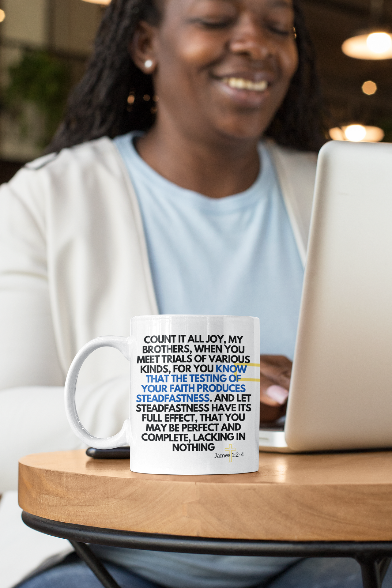 a woman sitting at a table with a laptop