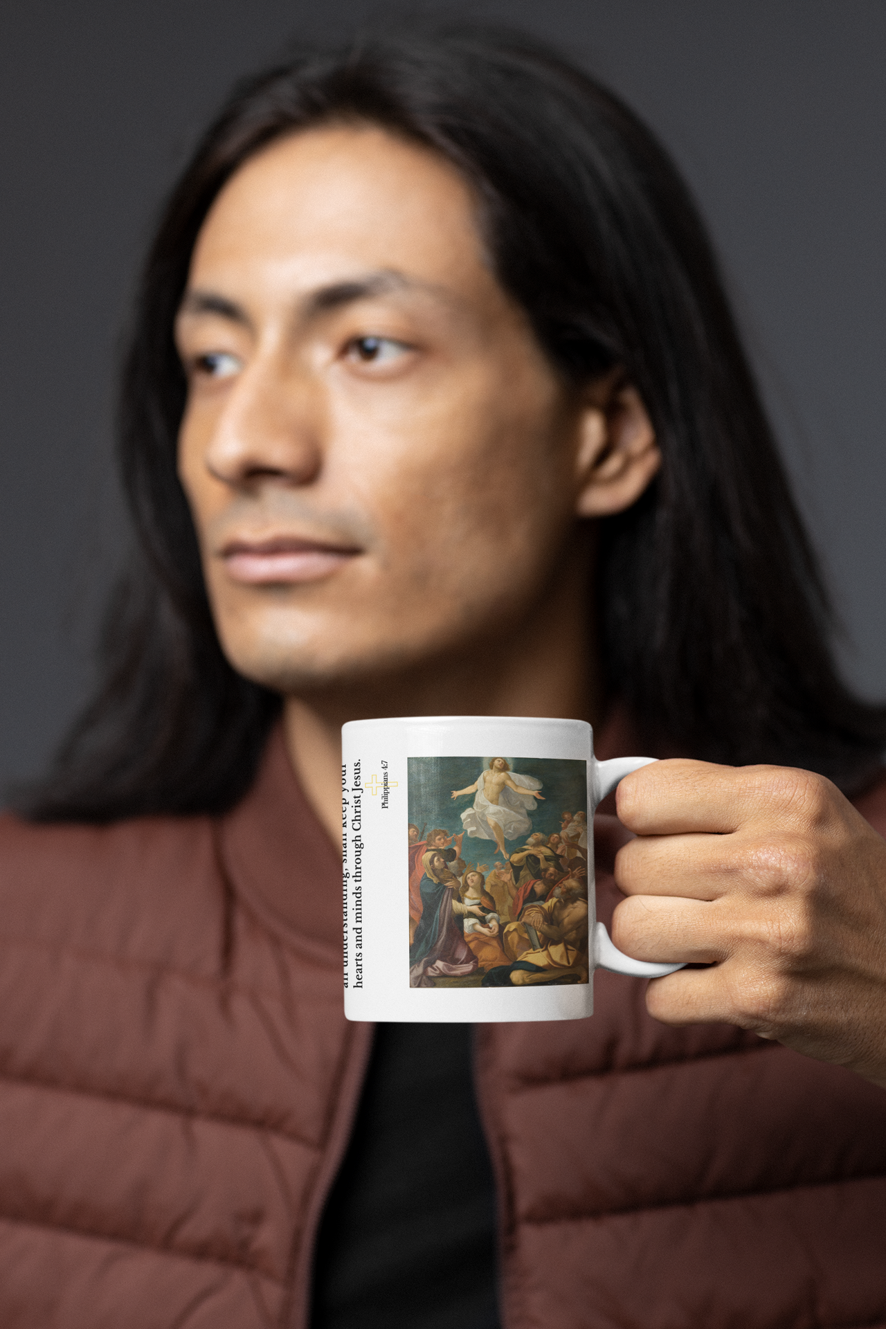 a man holding a coffee mug with a painting on it