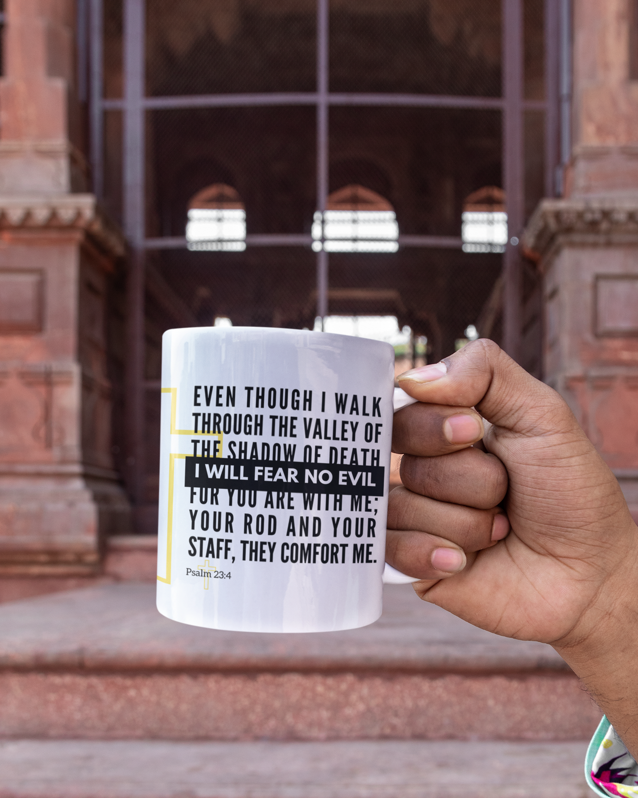 a person holding a coffee mug with a quote on it