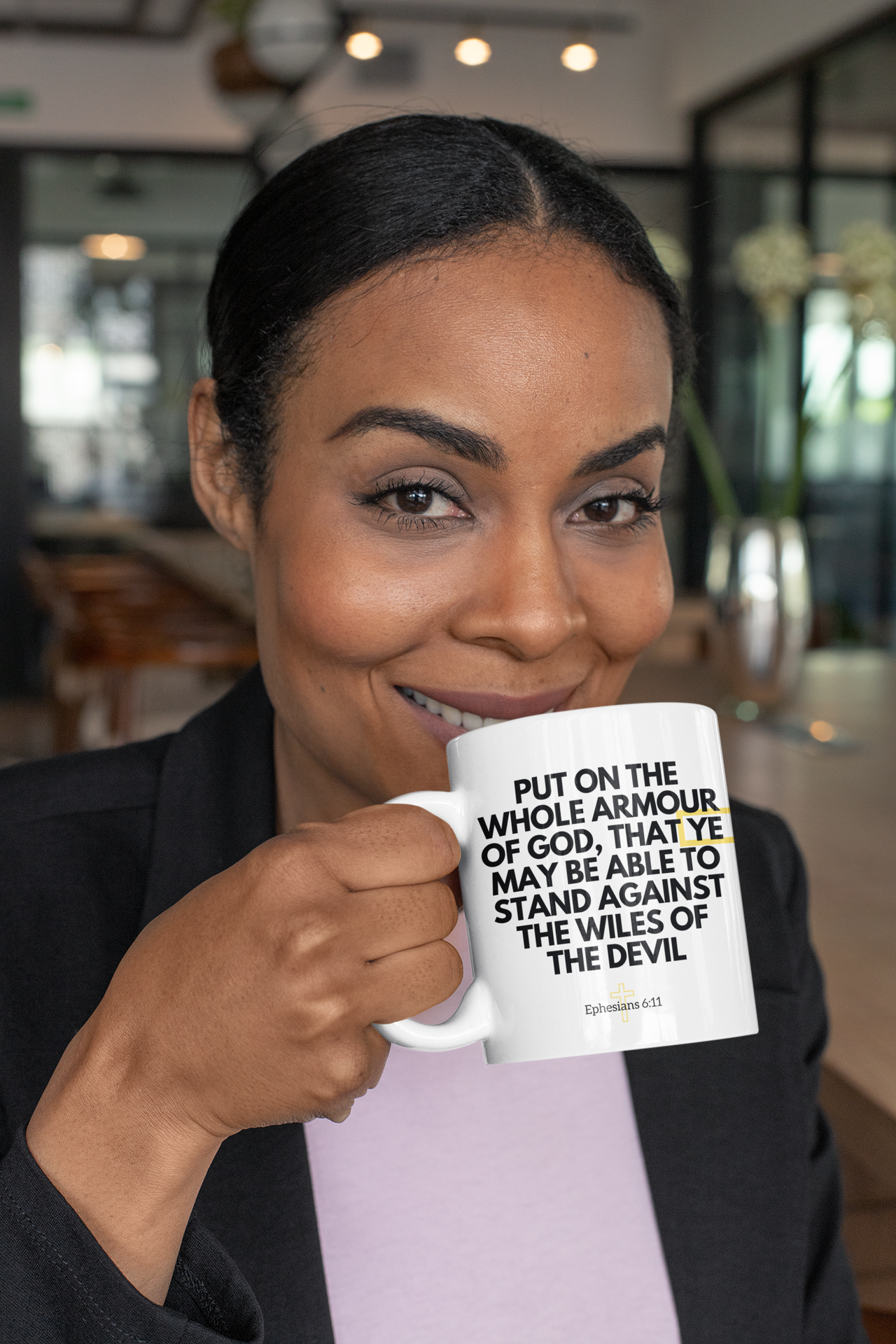 a woman holding a coffee mug with a quote on it