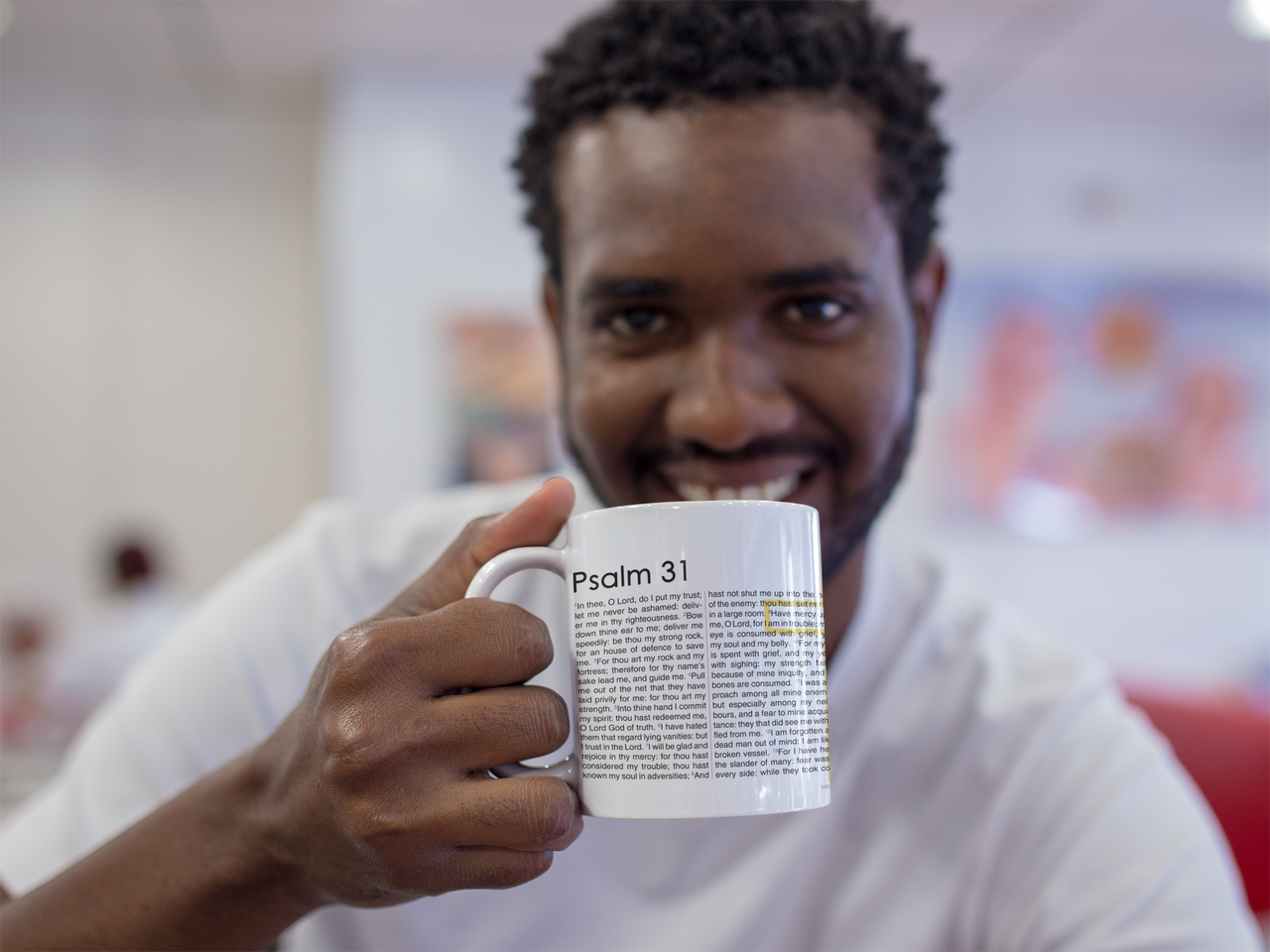 a man holding a coffee mug in his right hand