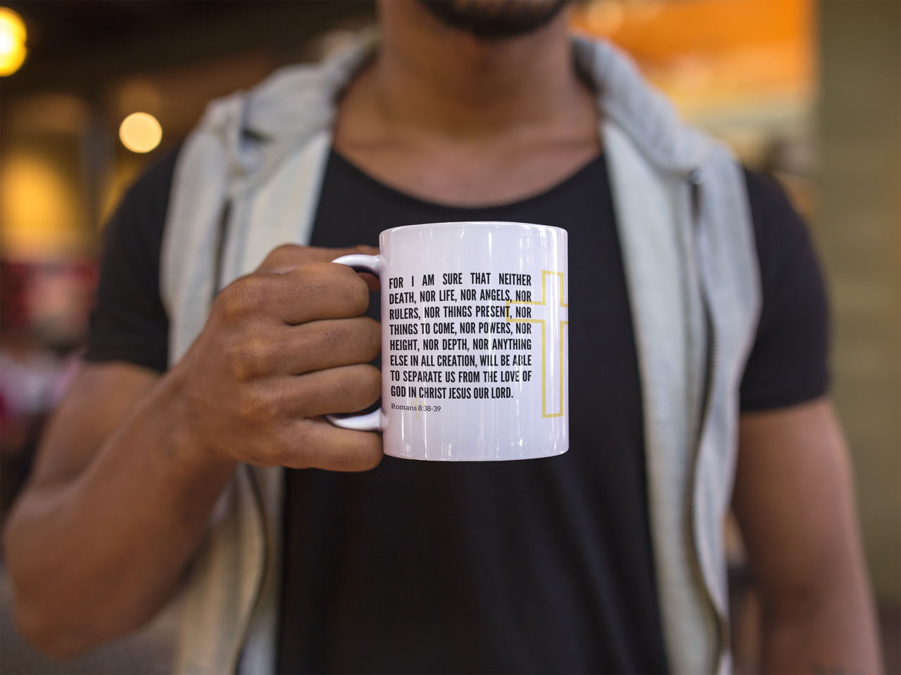 a man holding a coffee mug with a quote on it