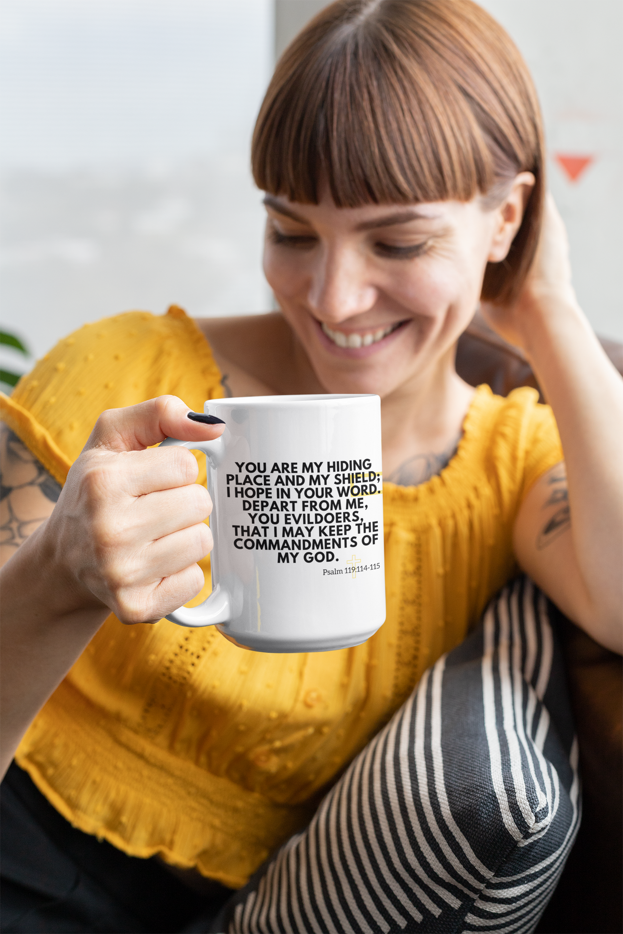 a woman sitting on a couch holding a coffee mug