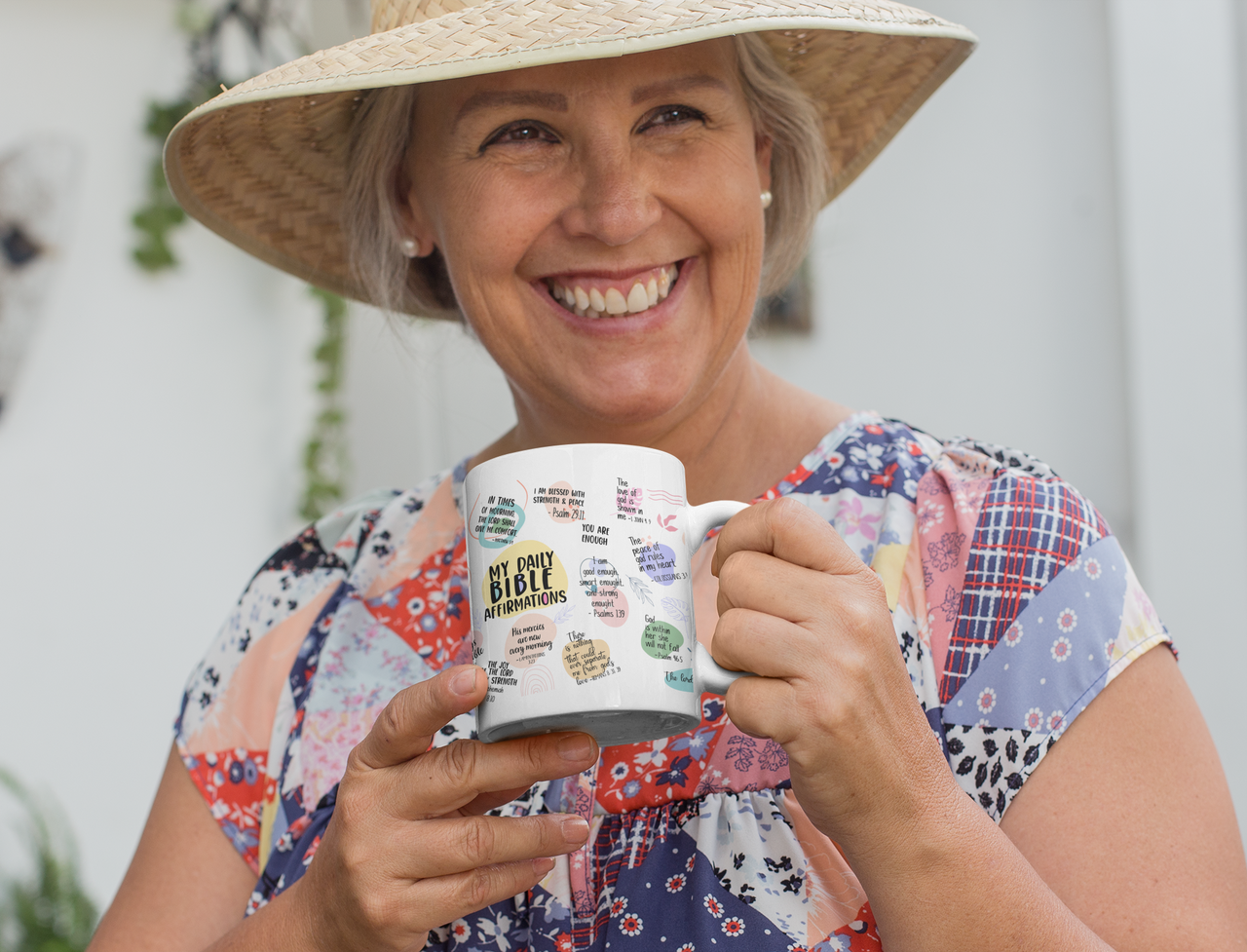 a woman wearing a straw hat holding a coffee mug