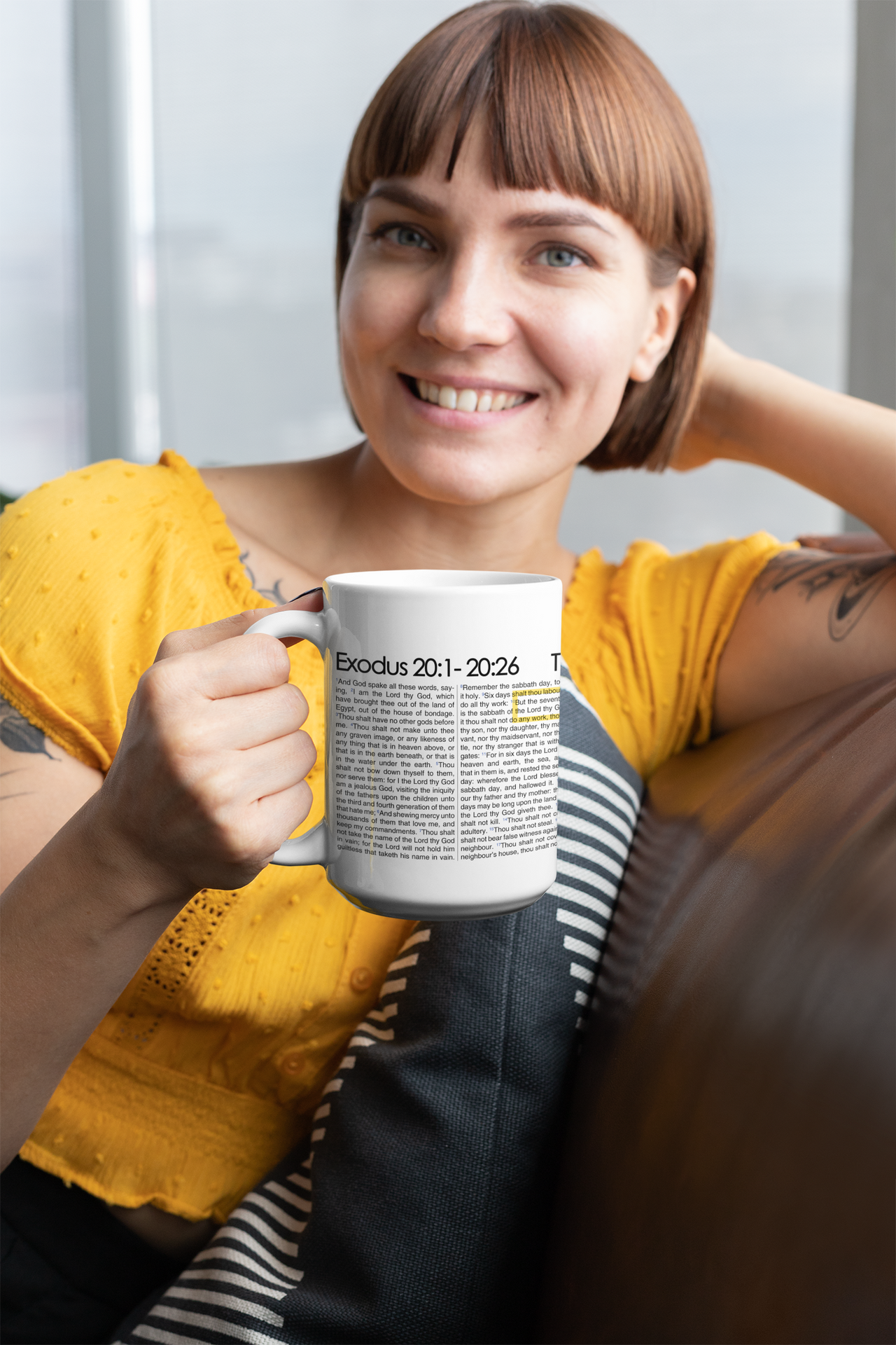 a woman sitting on a couch holding a coffee mug