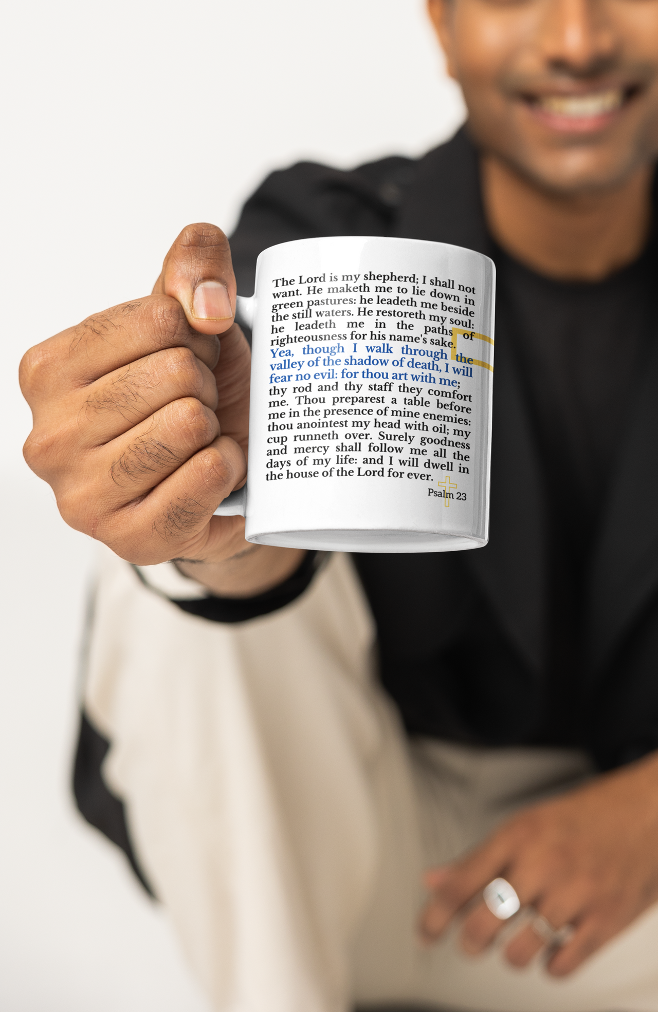 a man holding a coffee mug with a poem on it