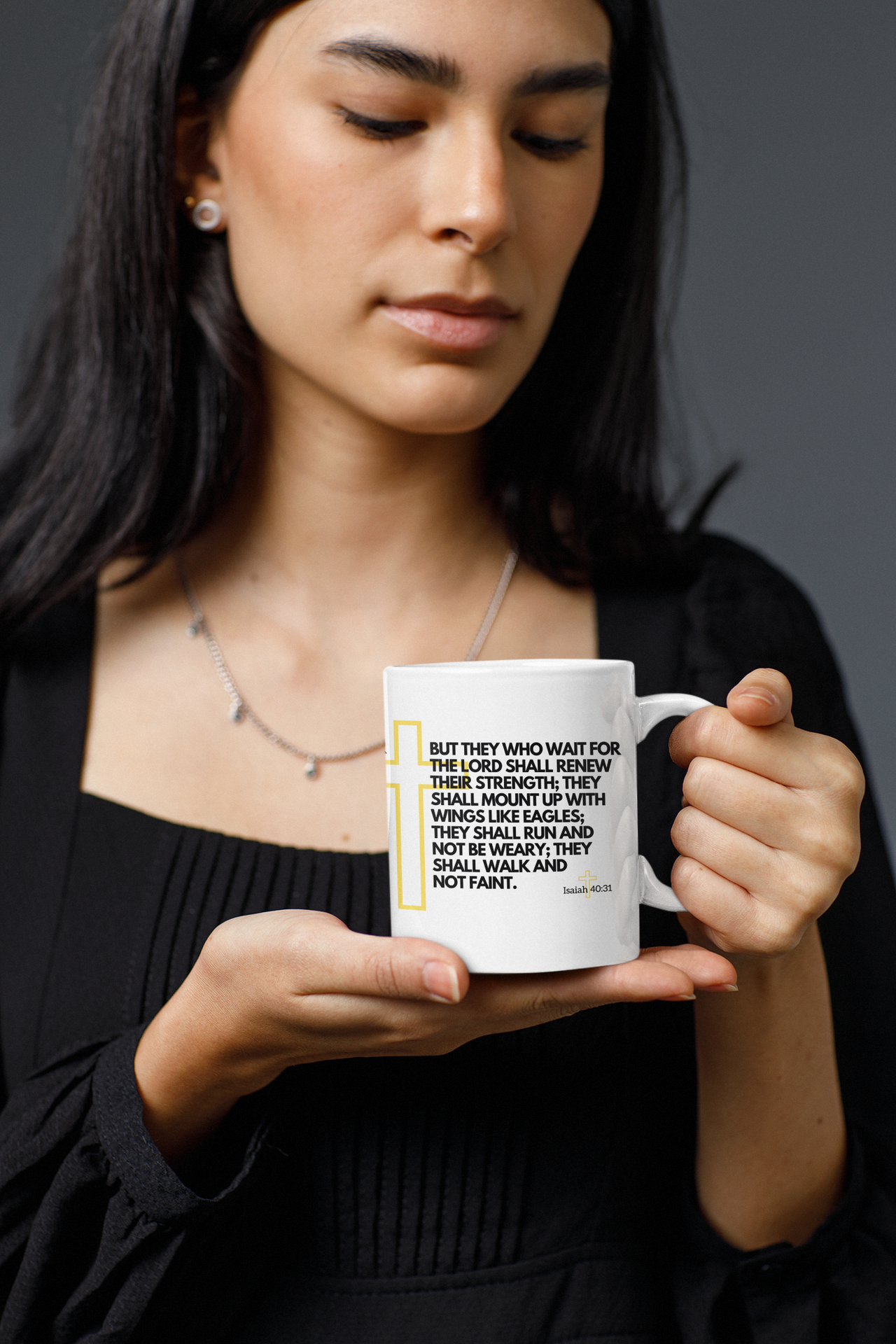 a woman holding a coffee mug with a quote on it