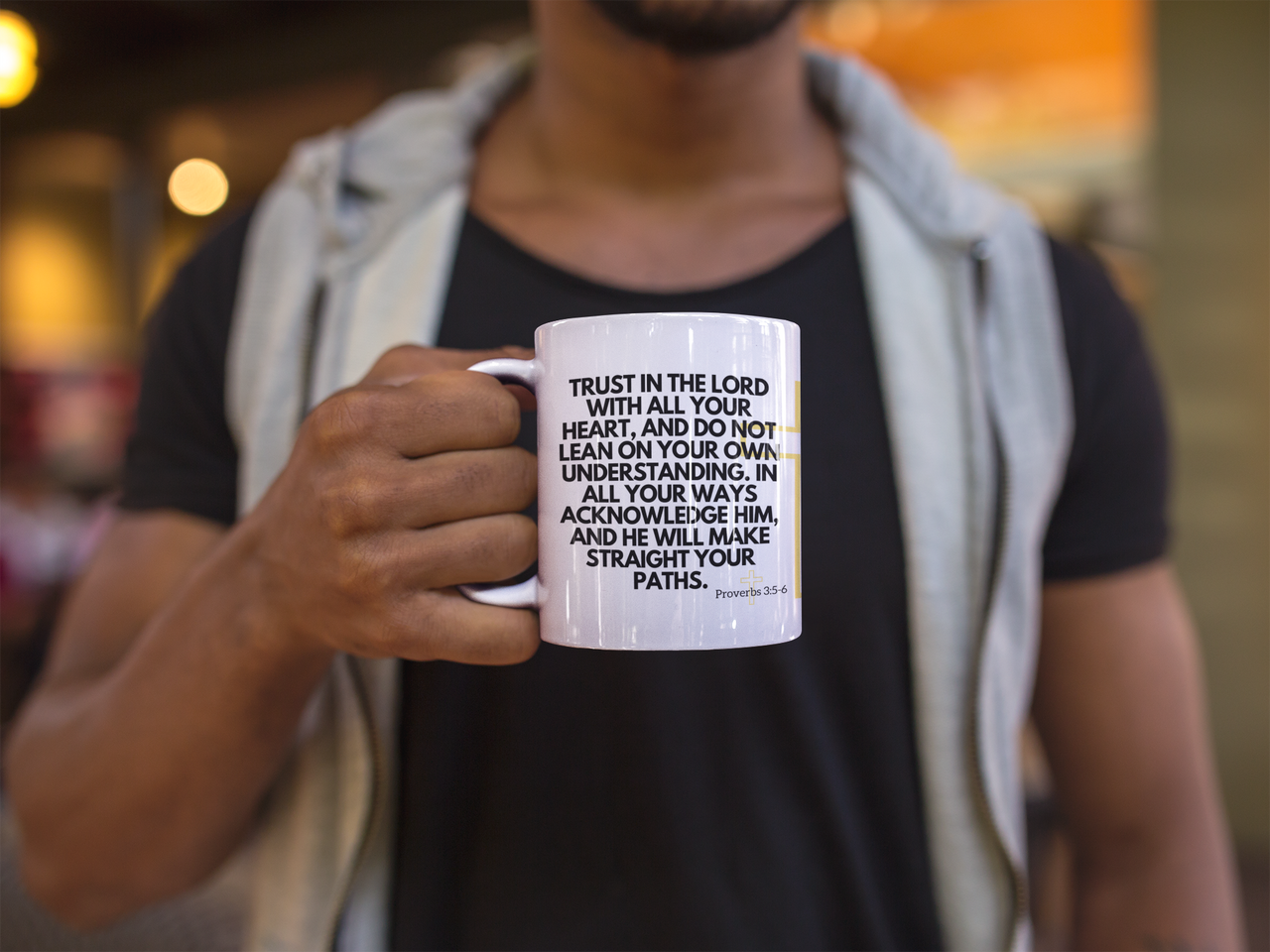 a man holding a coffee mug with a quote on it