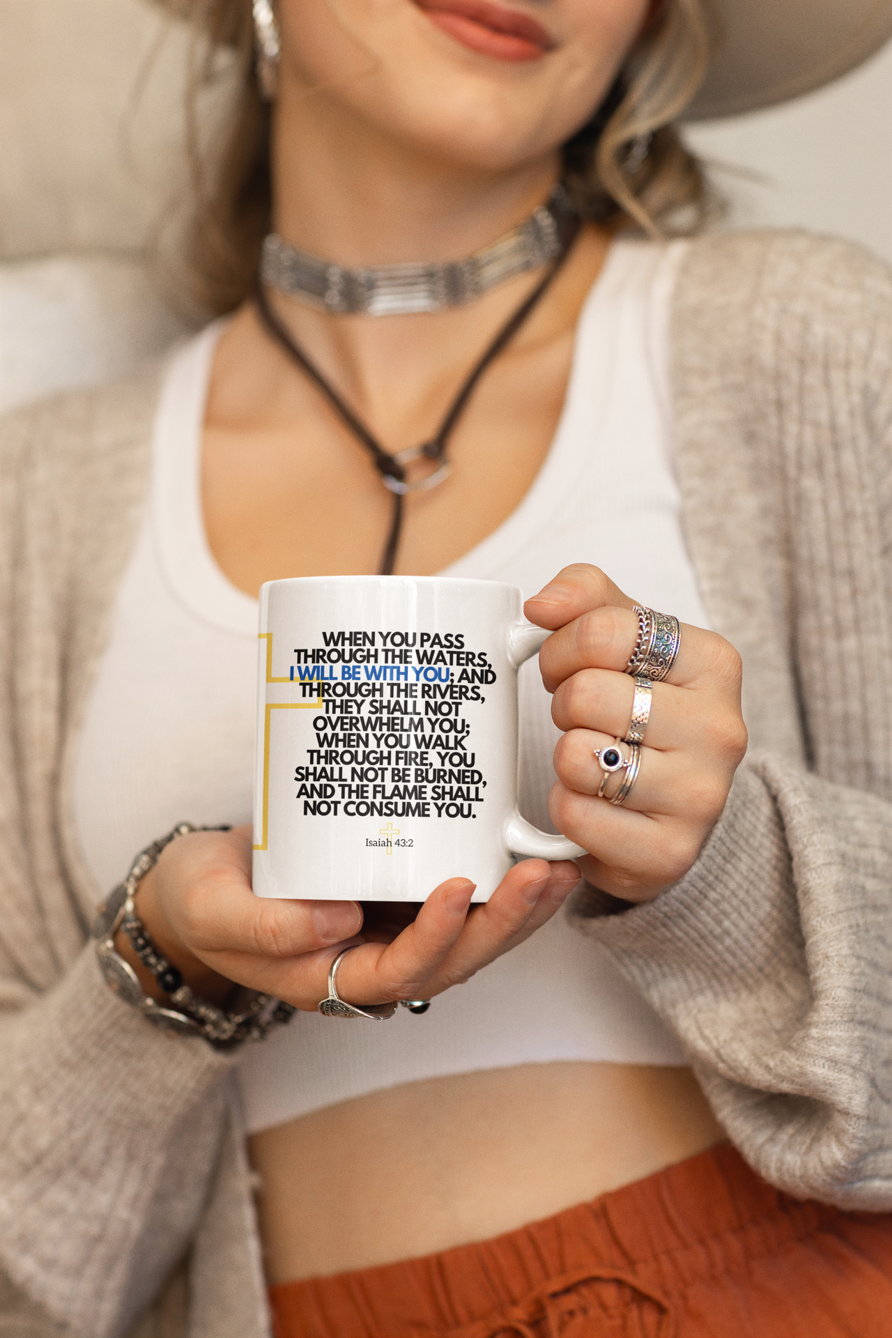 a woman wearing a hat holding a coffee mug