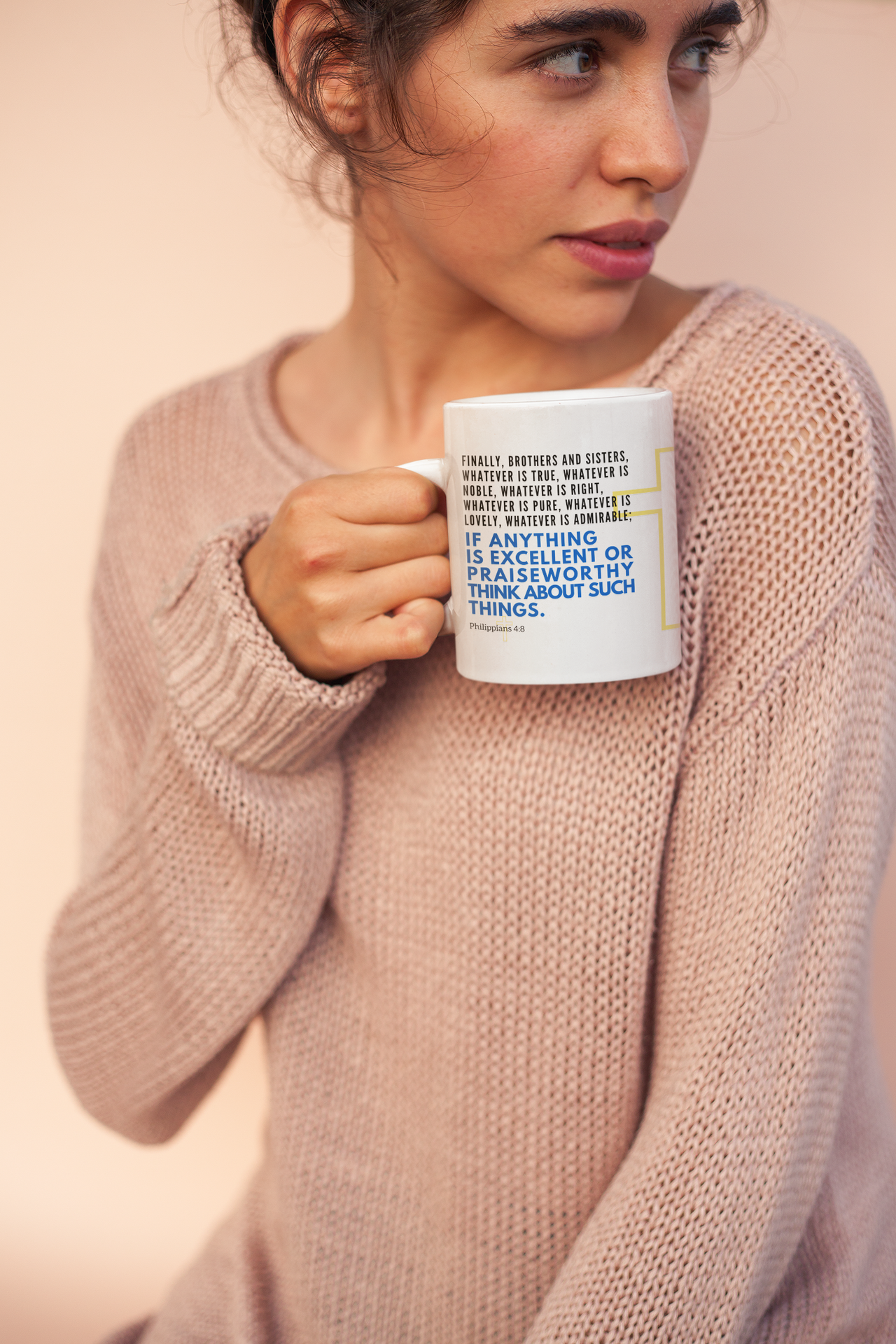 a woman is holding a coffee mug in her hands