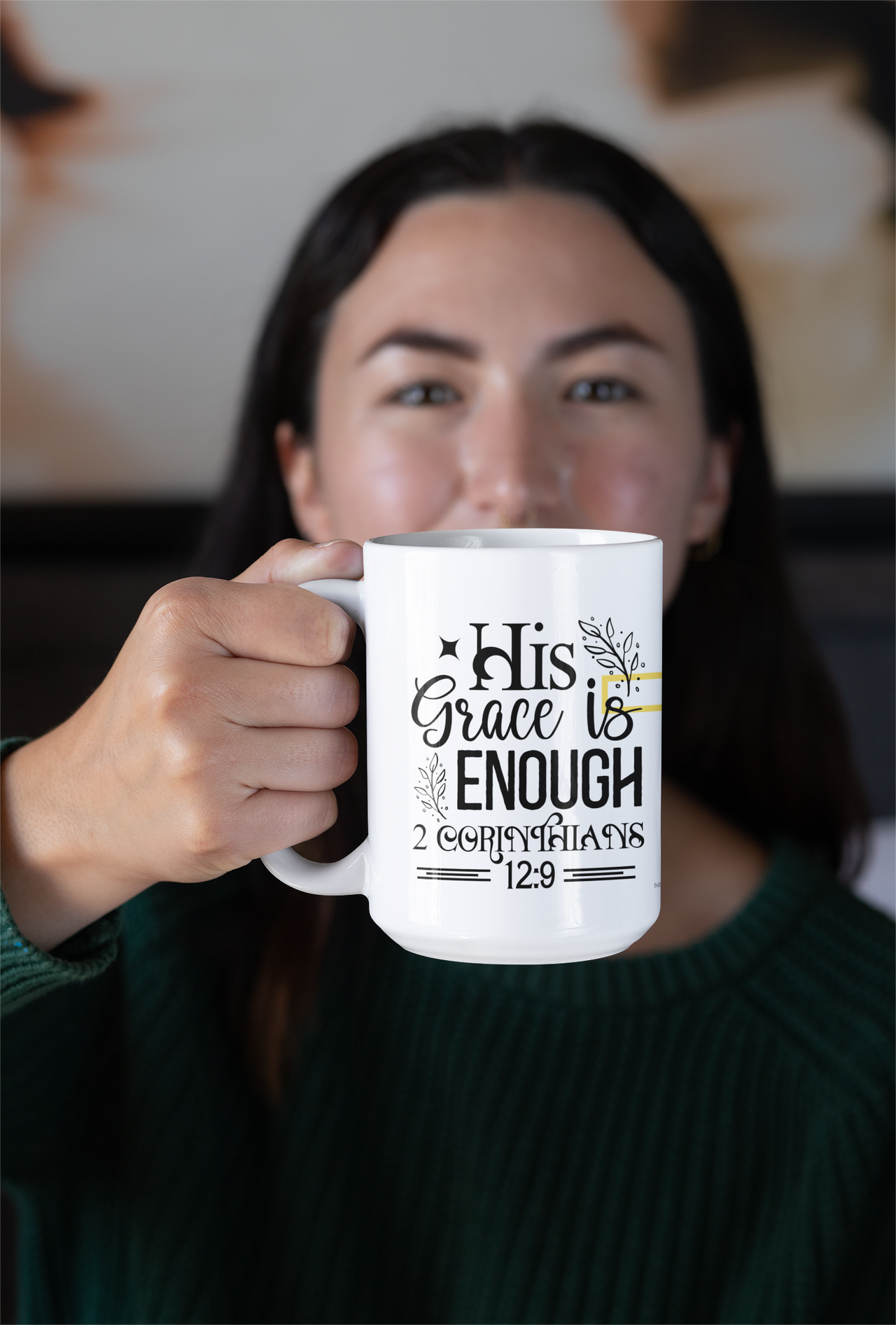 a woman holding a coffee mug with a message on it