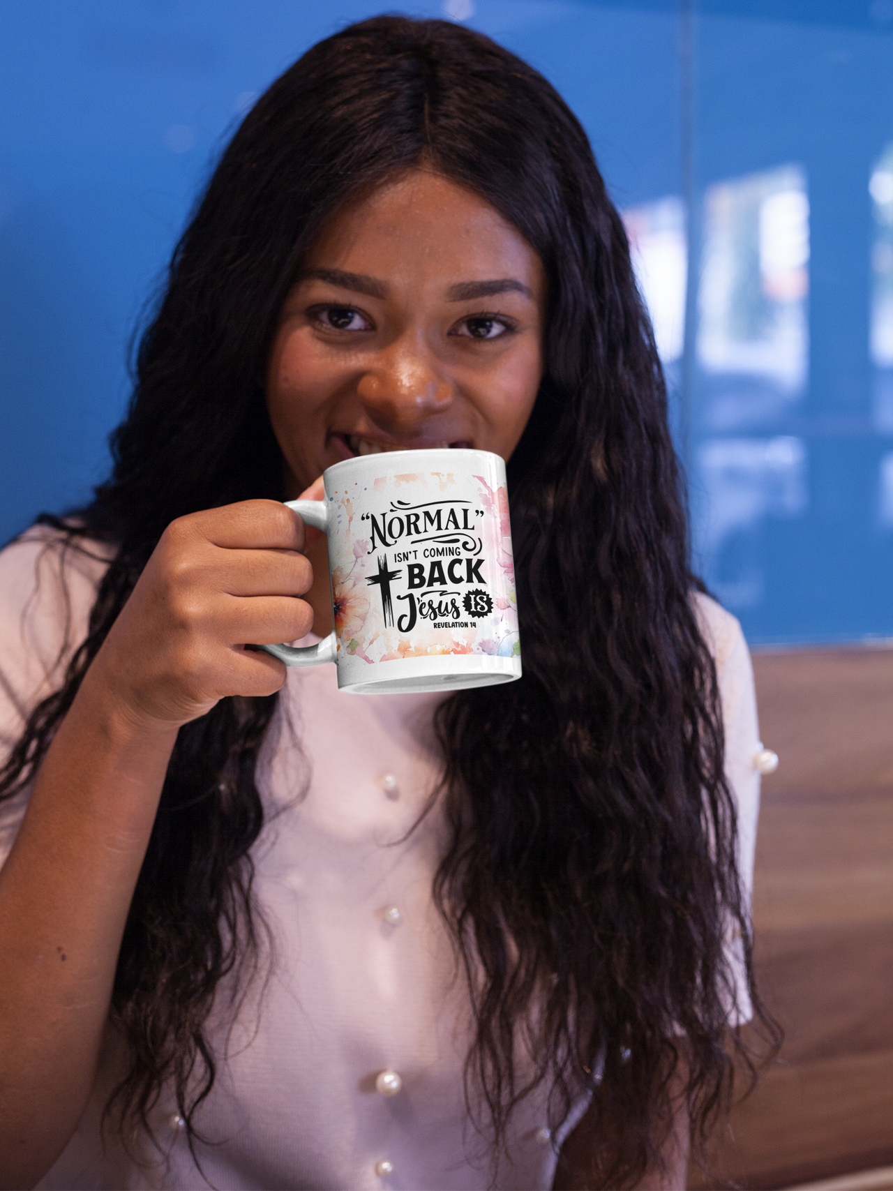 a woman is holding a coffee mug in her hand