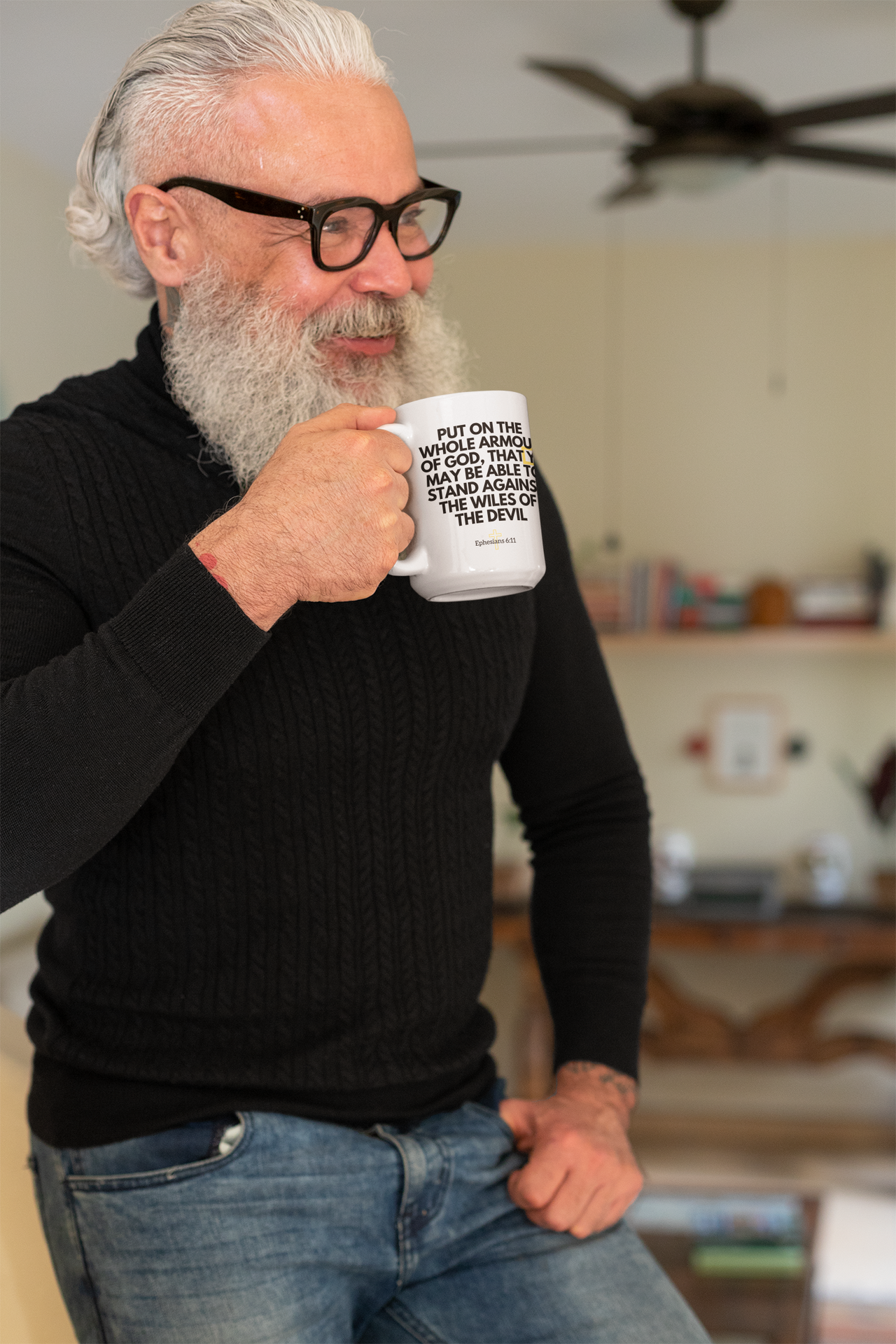 a man with a beard and glasses holding a coffee mug