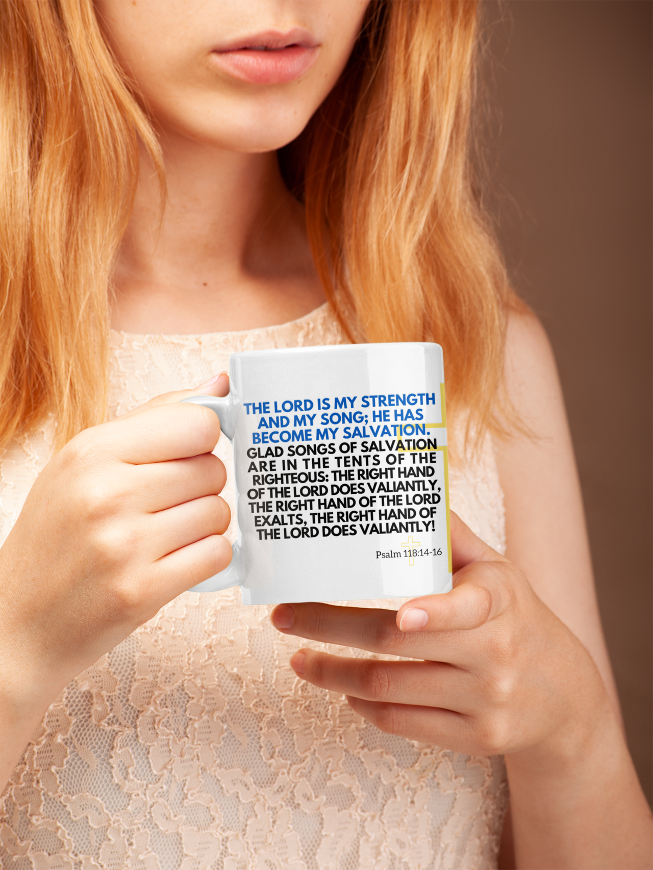 a woman holding a coffee mug with a bible verse on it