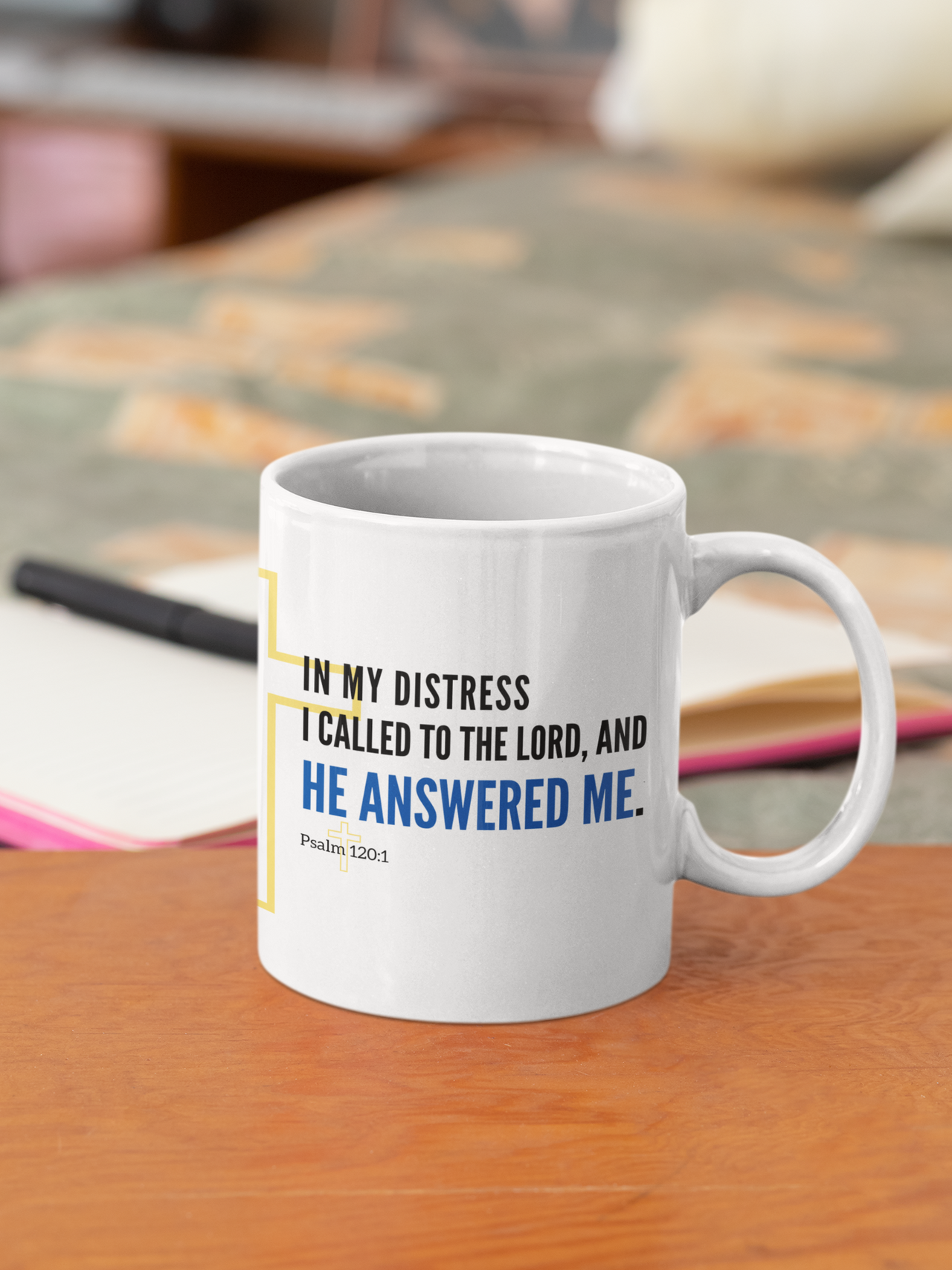 a white coffee mug sitting on top of a wooden table