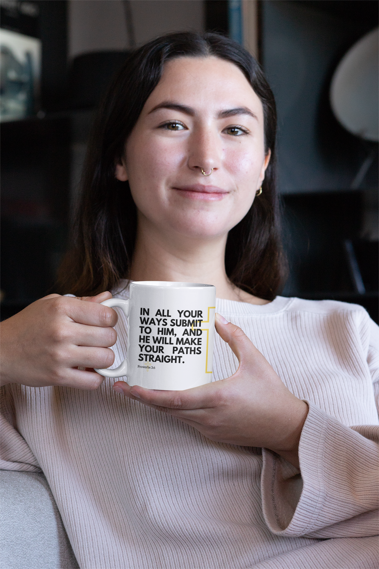 a woman holding a coffee mug with a quote on it