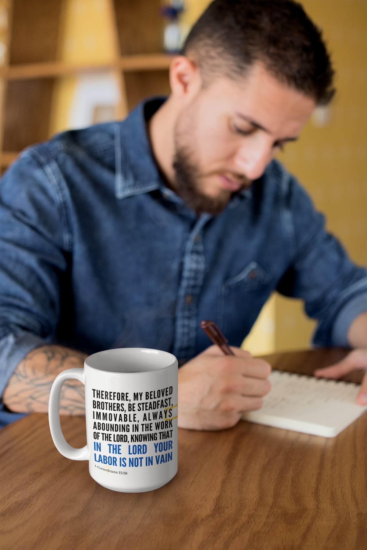 a man sitting at a table writing on a notepad