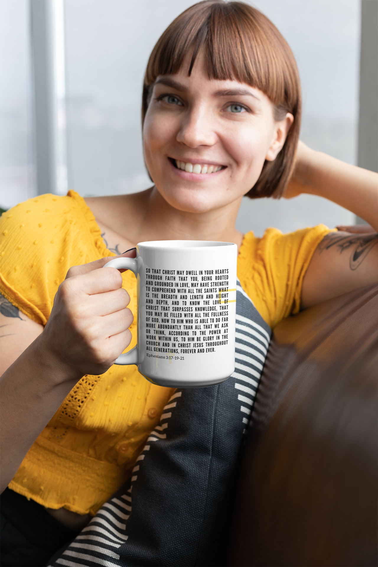 a woman sitting on a couch holding a coffee mug