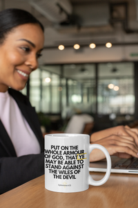 Thumbnail for a woman sitting at a table with a coffee mug in front of her