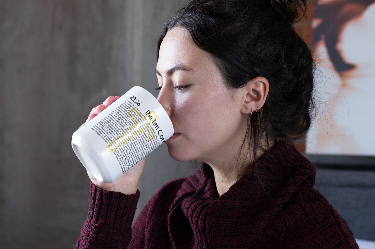 a woman drinking out of a coffee cup