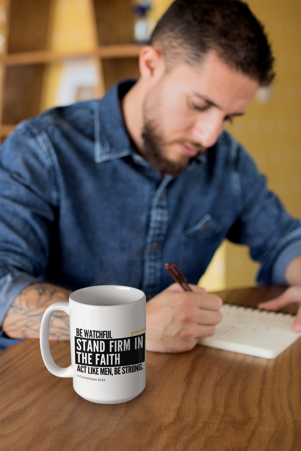 a man sitting at a table writing on a notepad