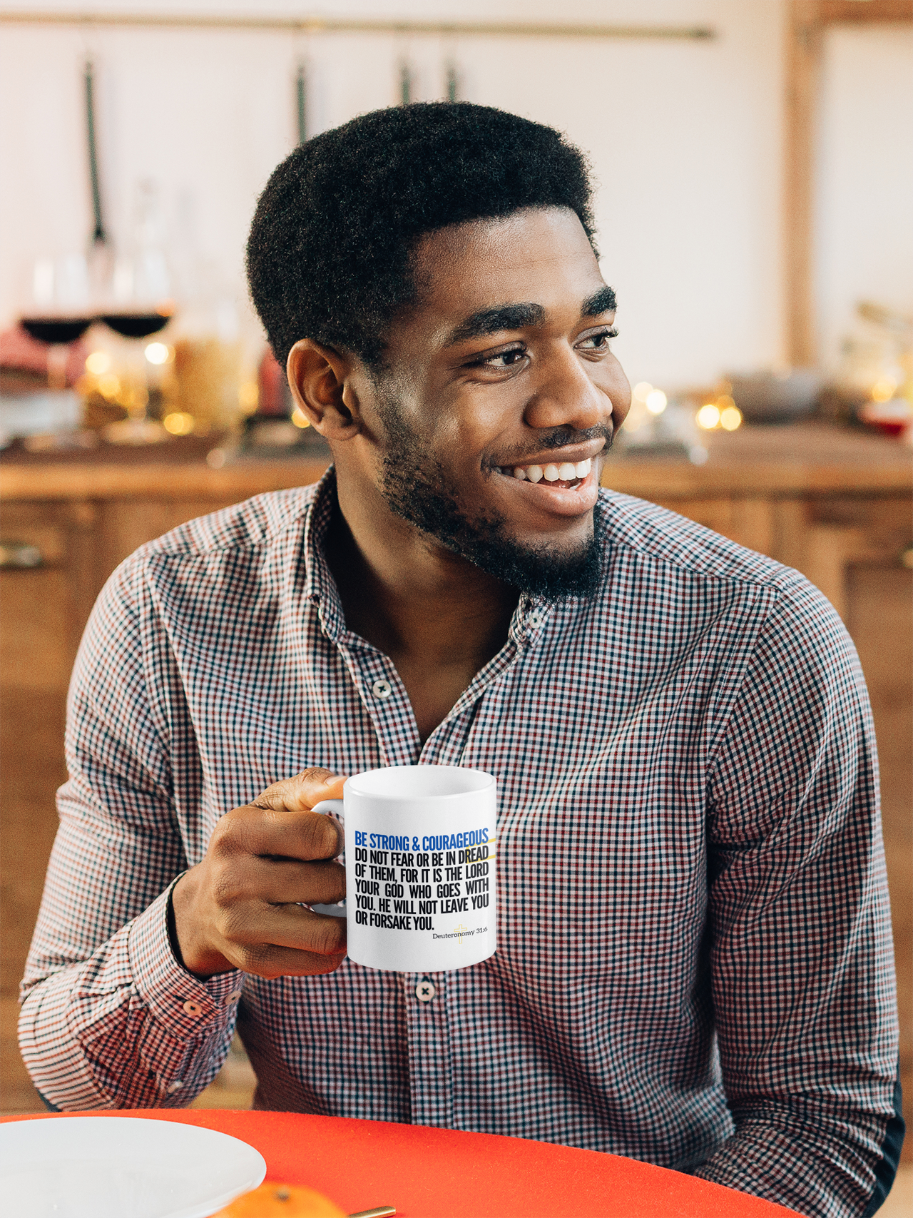 a man sitting at a table holding a coffee mug