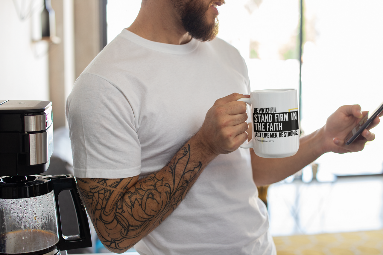 a man holding a cup of coffee and a cell phone