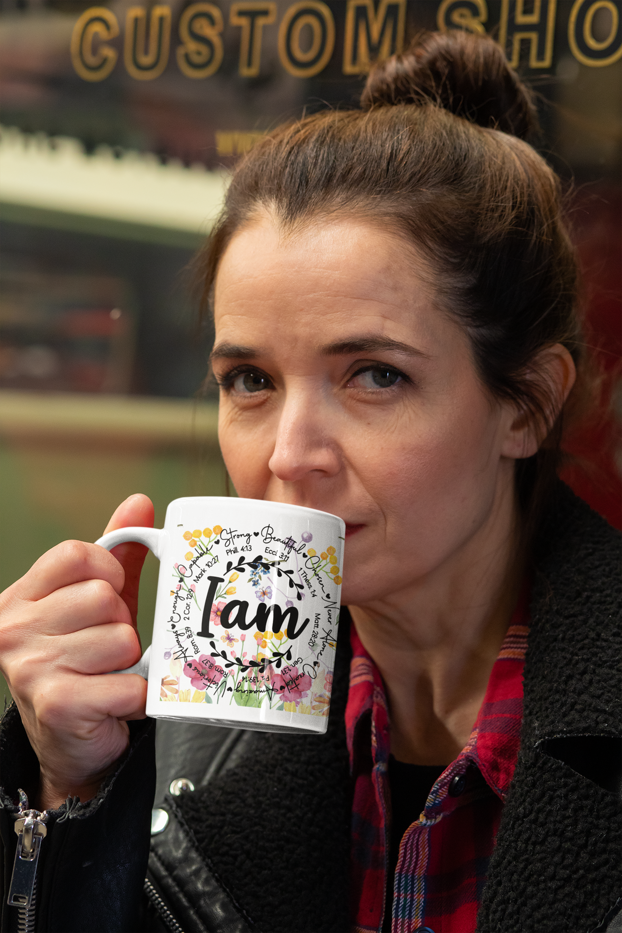 a woman holding a coffee mug in her hand