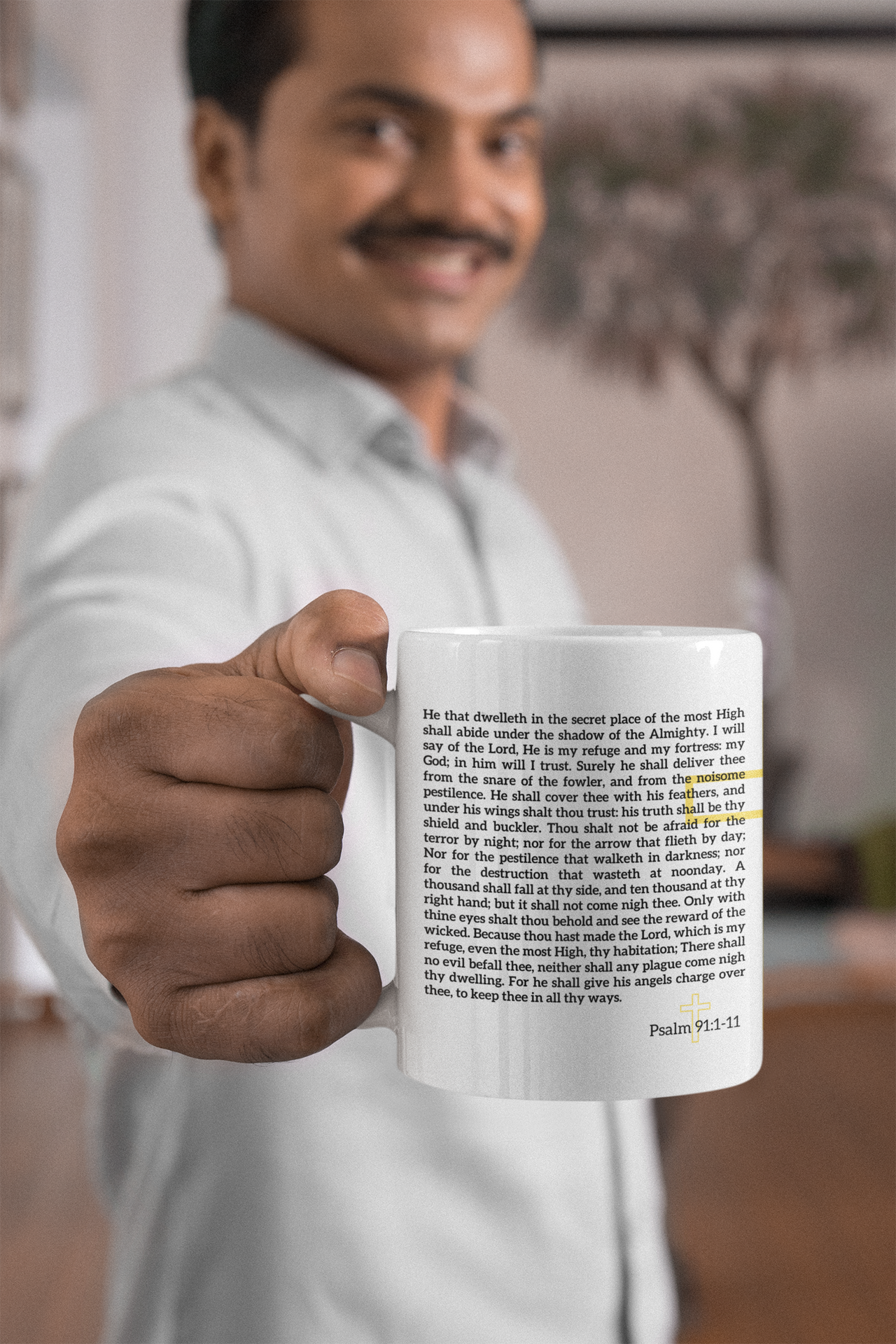 a man in a white shirt is holding a coffee mug