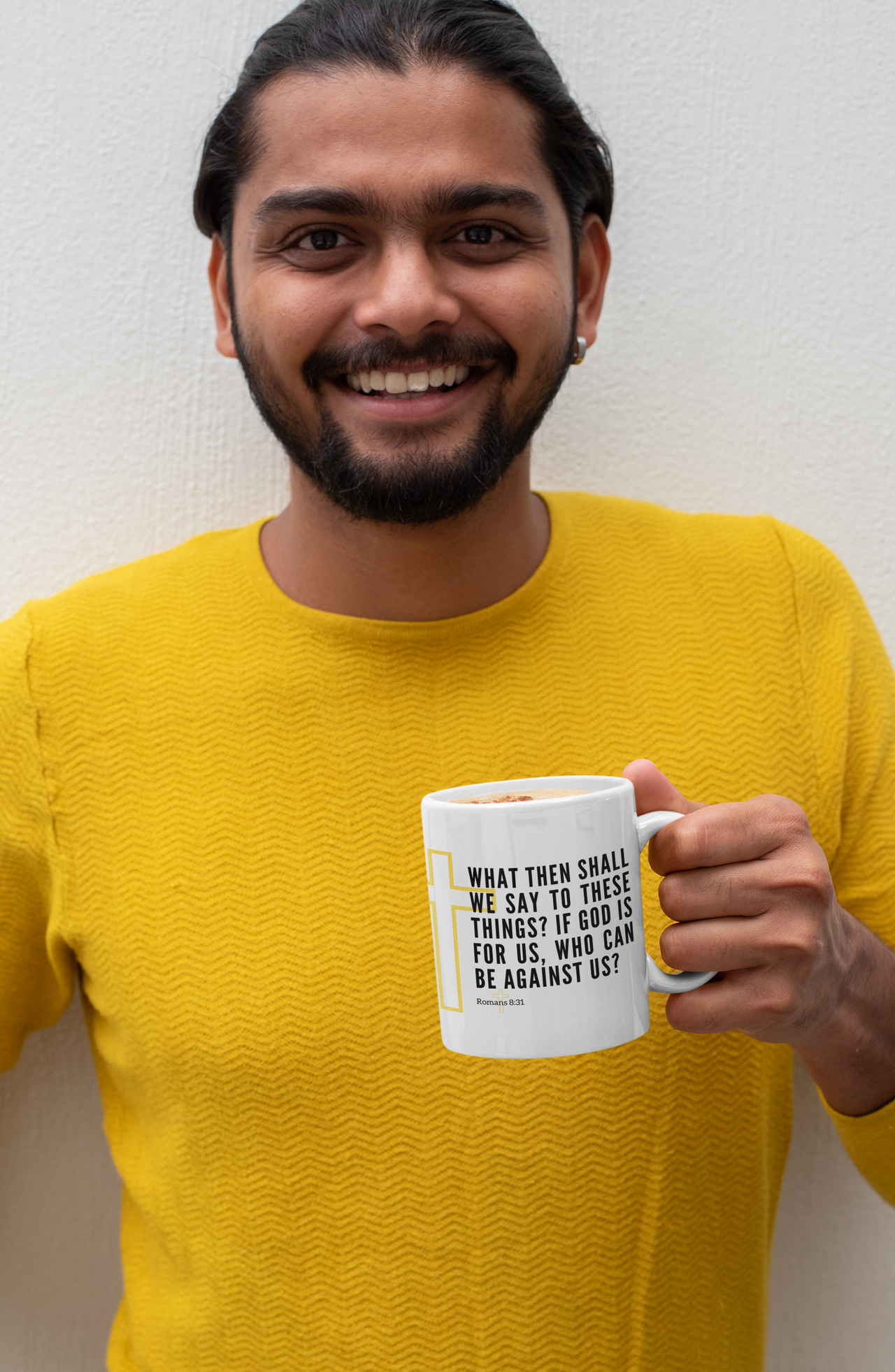 a man with a beard holding a coffee mug