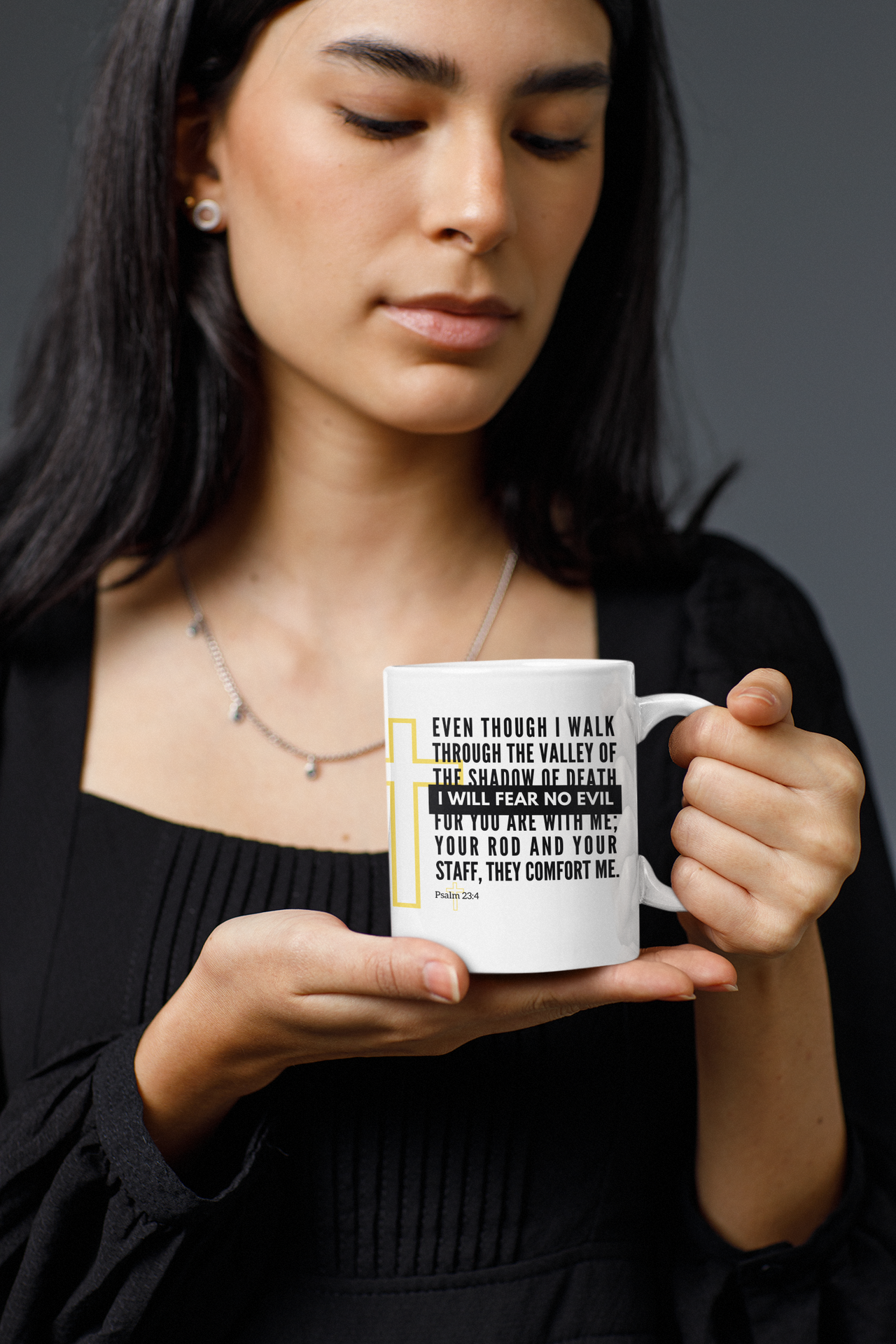 a woman holding a coffee mug with a quote on it