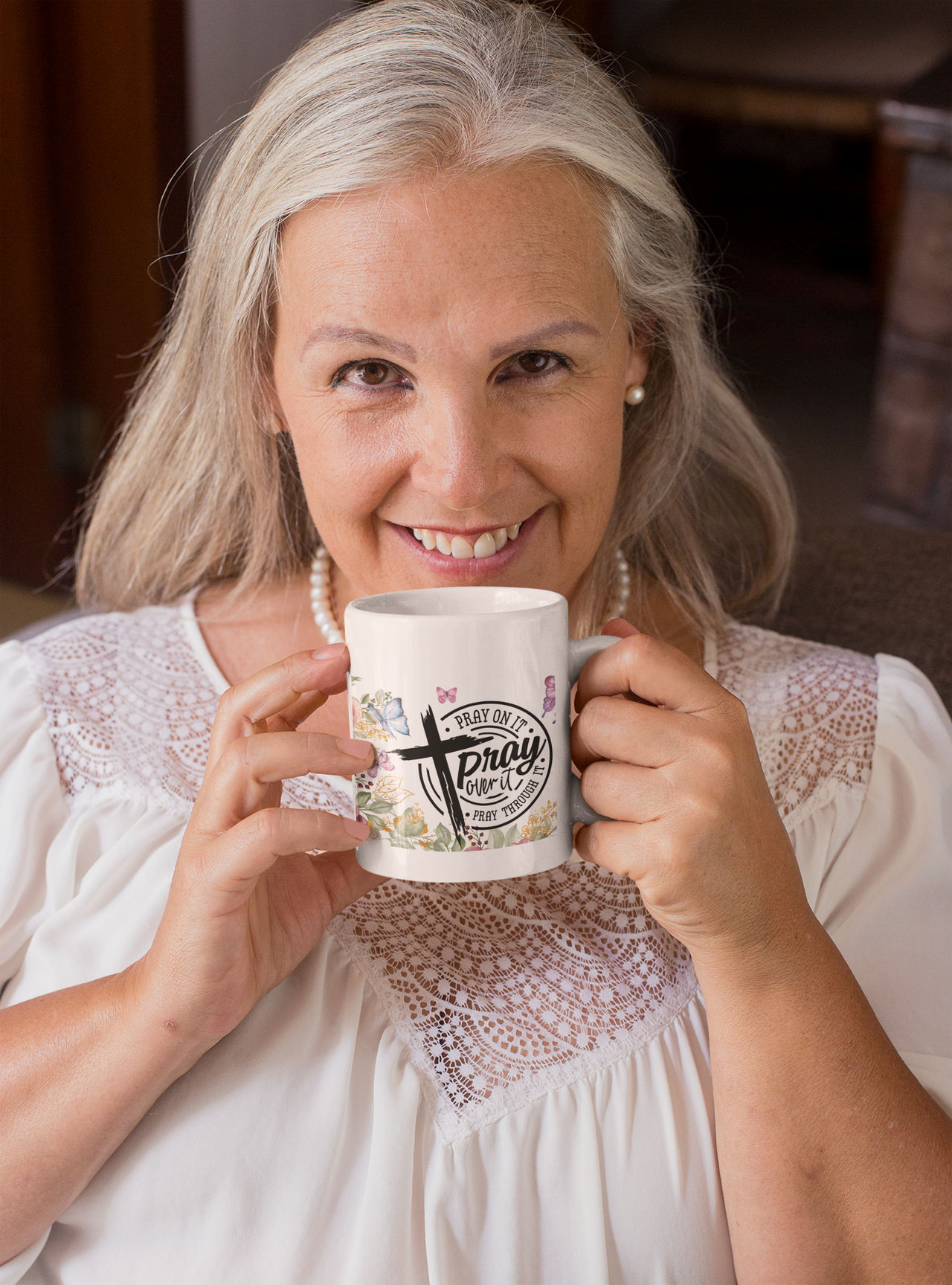 a woman is holding a coffee mug in her hands