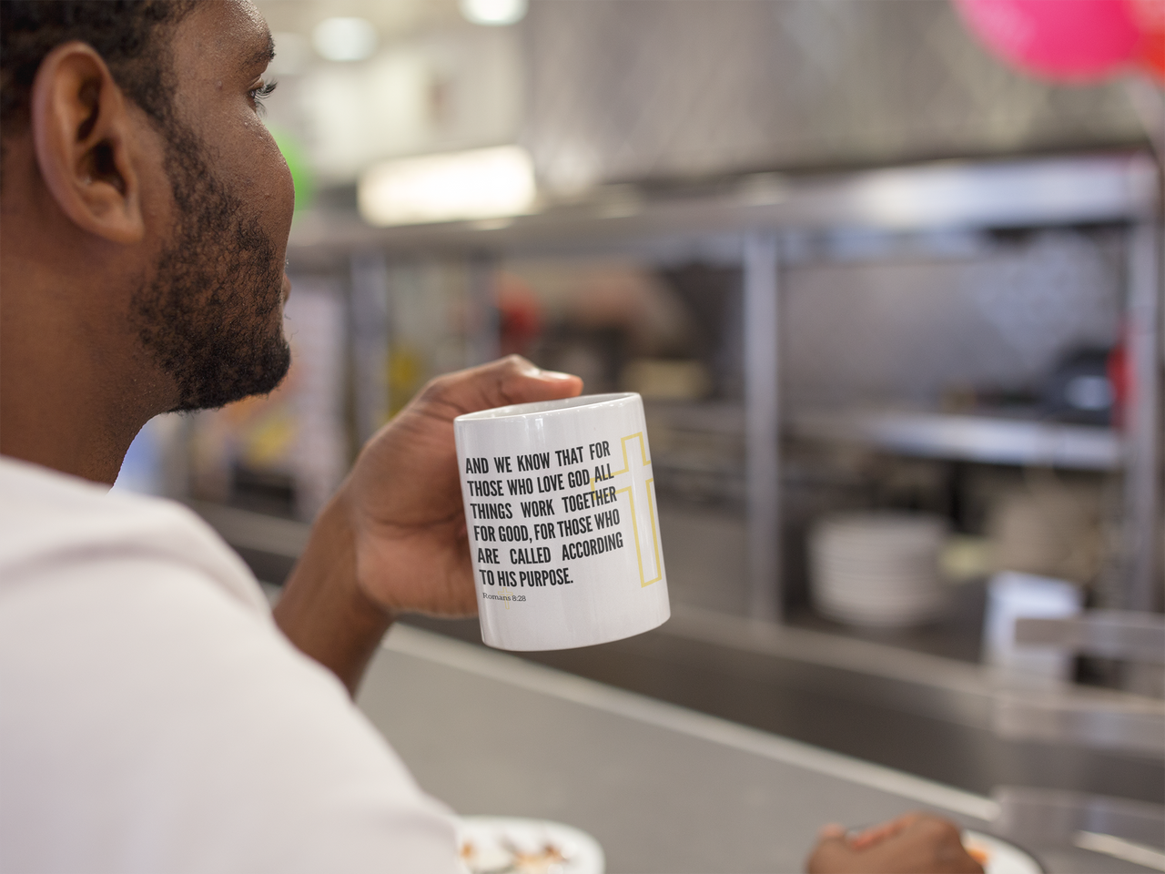 a man is holding a coffee mug in his hand