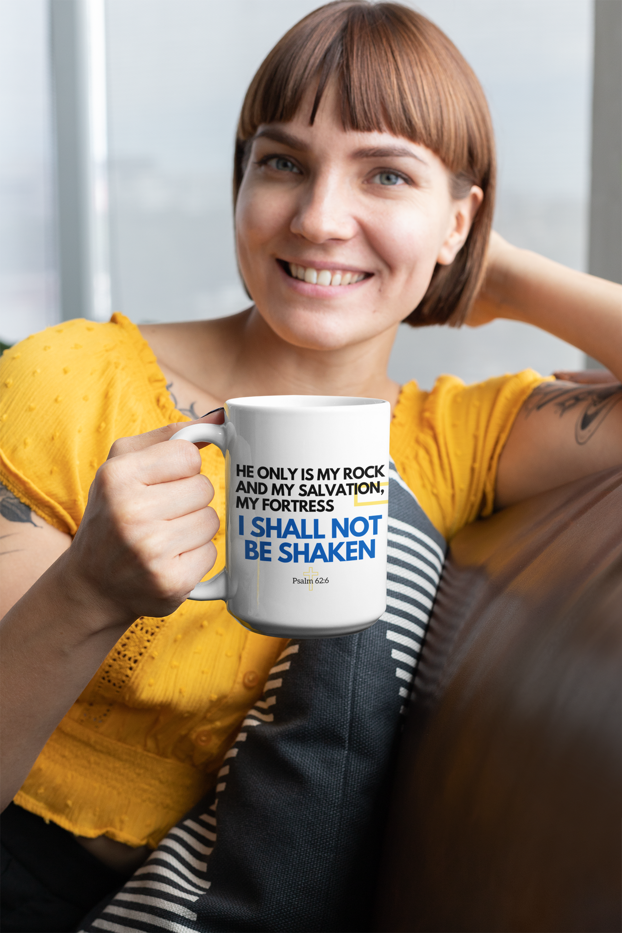 a woman sitting on a couch holding a coffee mug