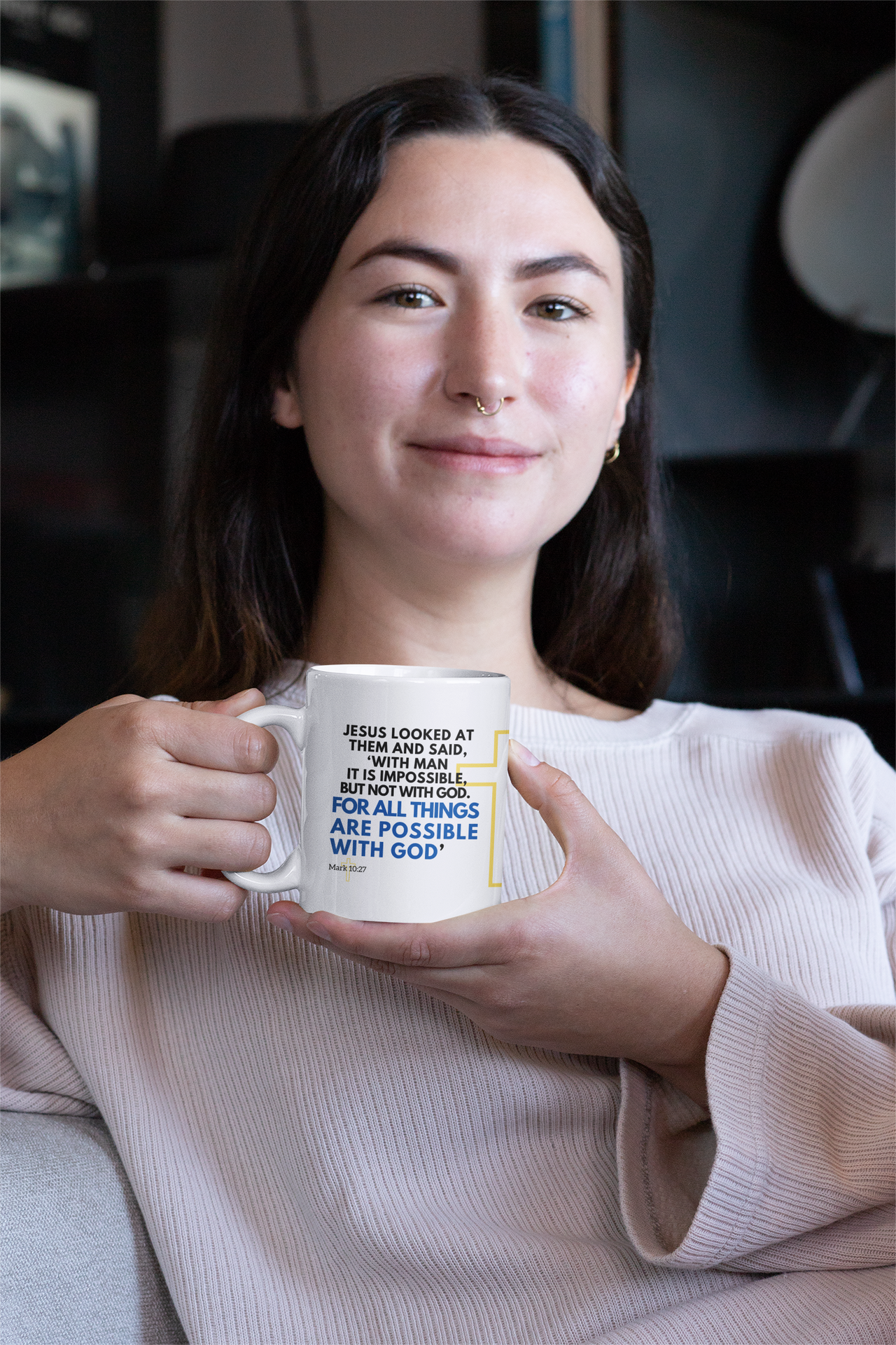 a woman is holding a coffee mug in her hands