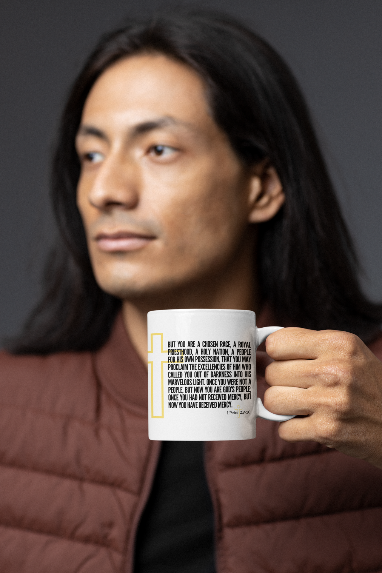 a man with long hair holding a coffee mug