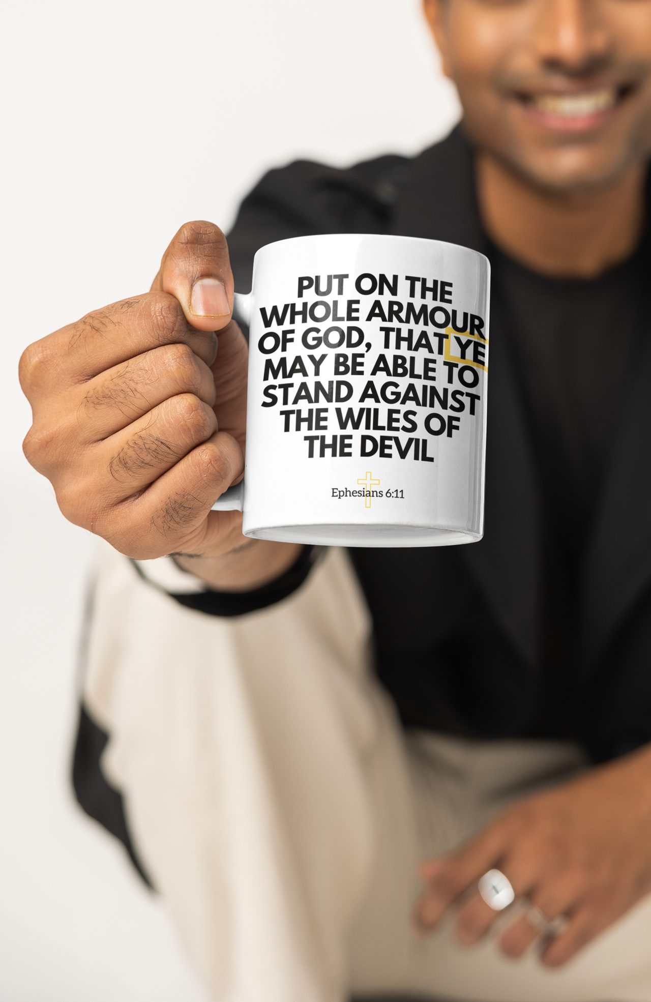 a man holding a coffee mug with a quote on it