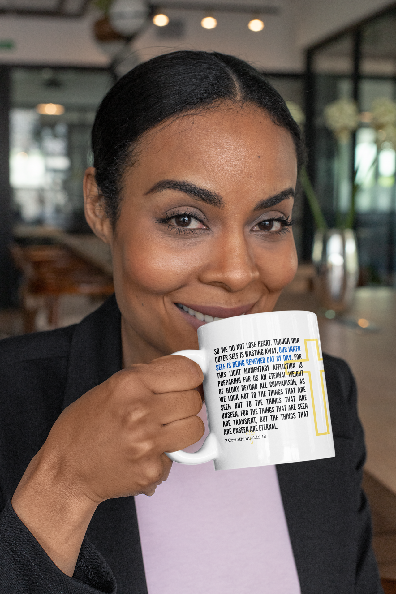 a woman is holding a coffee mug in her hands