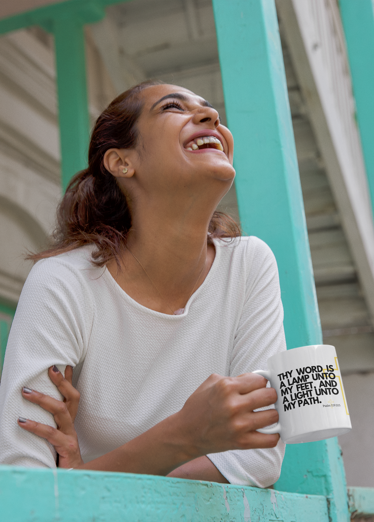 a woman smiling while holding a coffee mug