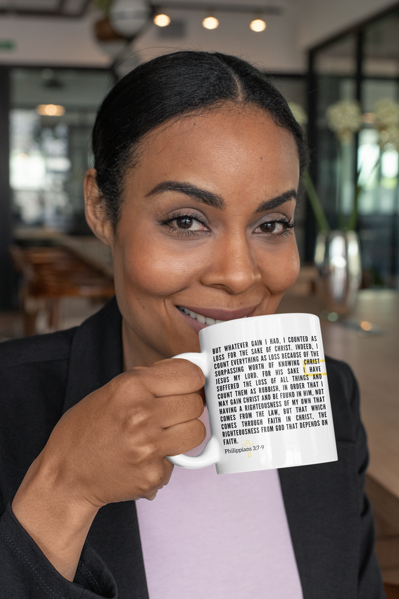 a woman is holding a coffee mug in her hands