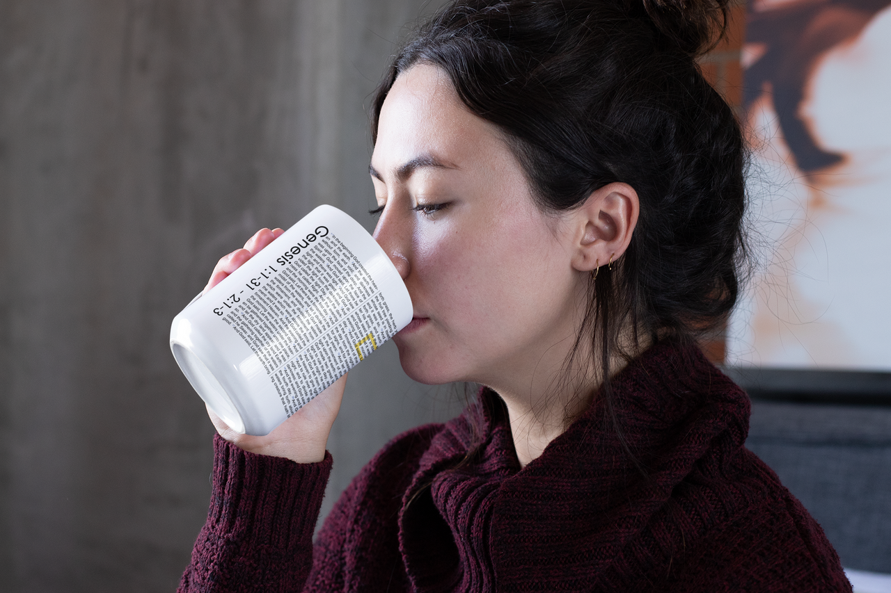 a woman drinking out of a white cup