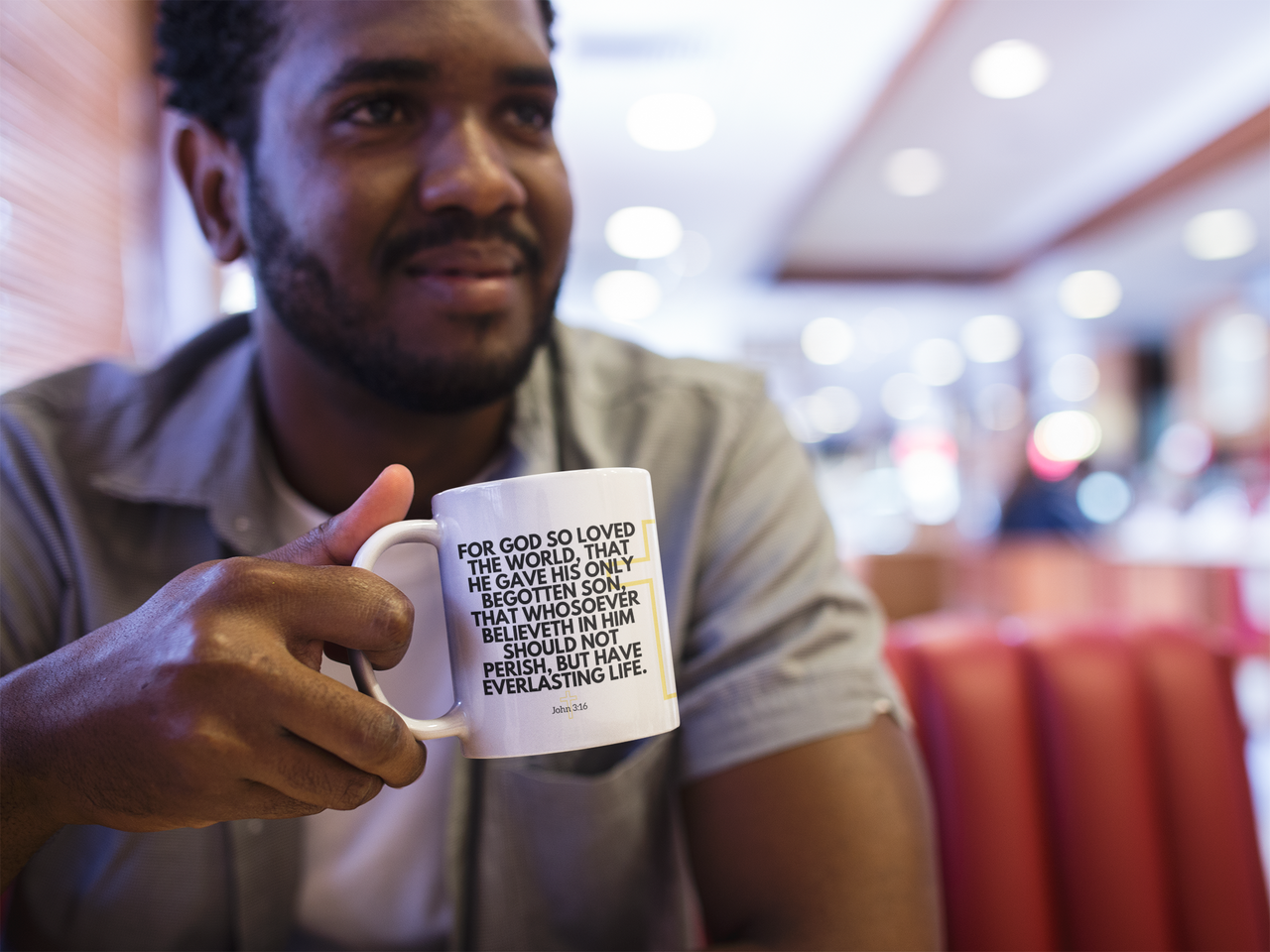 a man holding a coffee mug with a quote on it