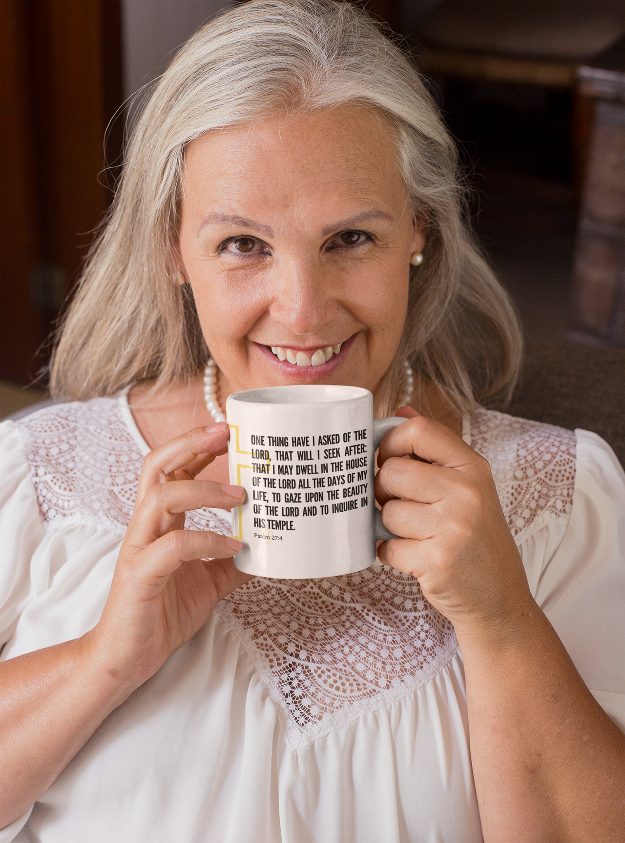 a woman is holding a coffee mug in her hands